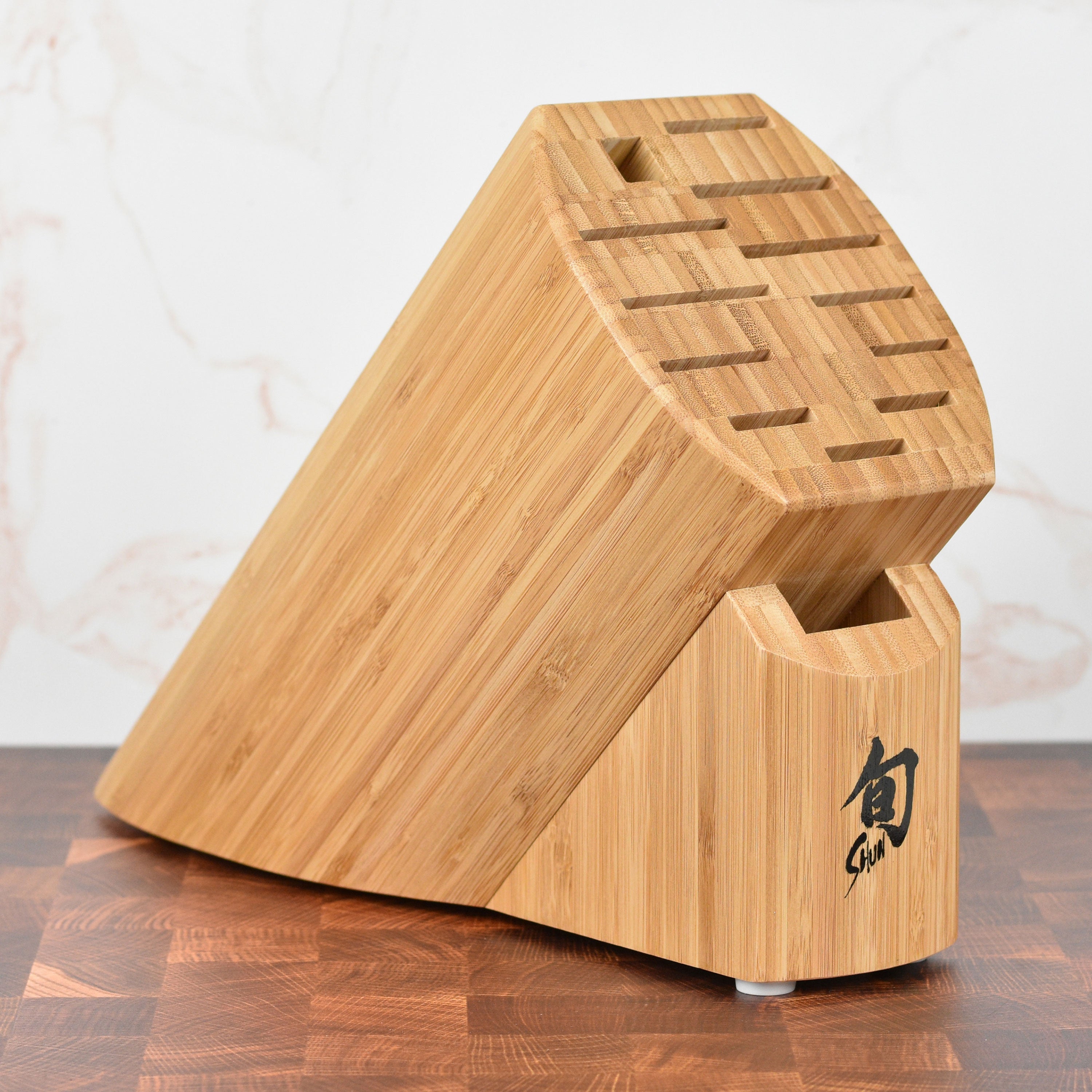 Shun 13-Slot Bamboo Knife Block showcasing its knife slots and sharpening steel space.