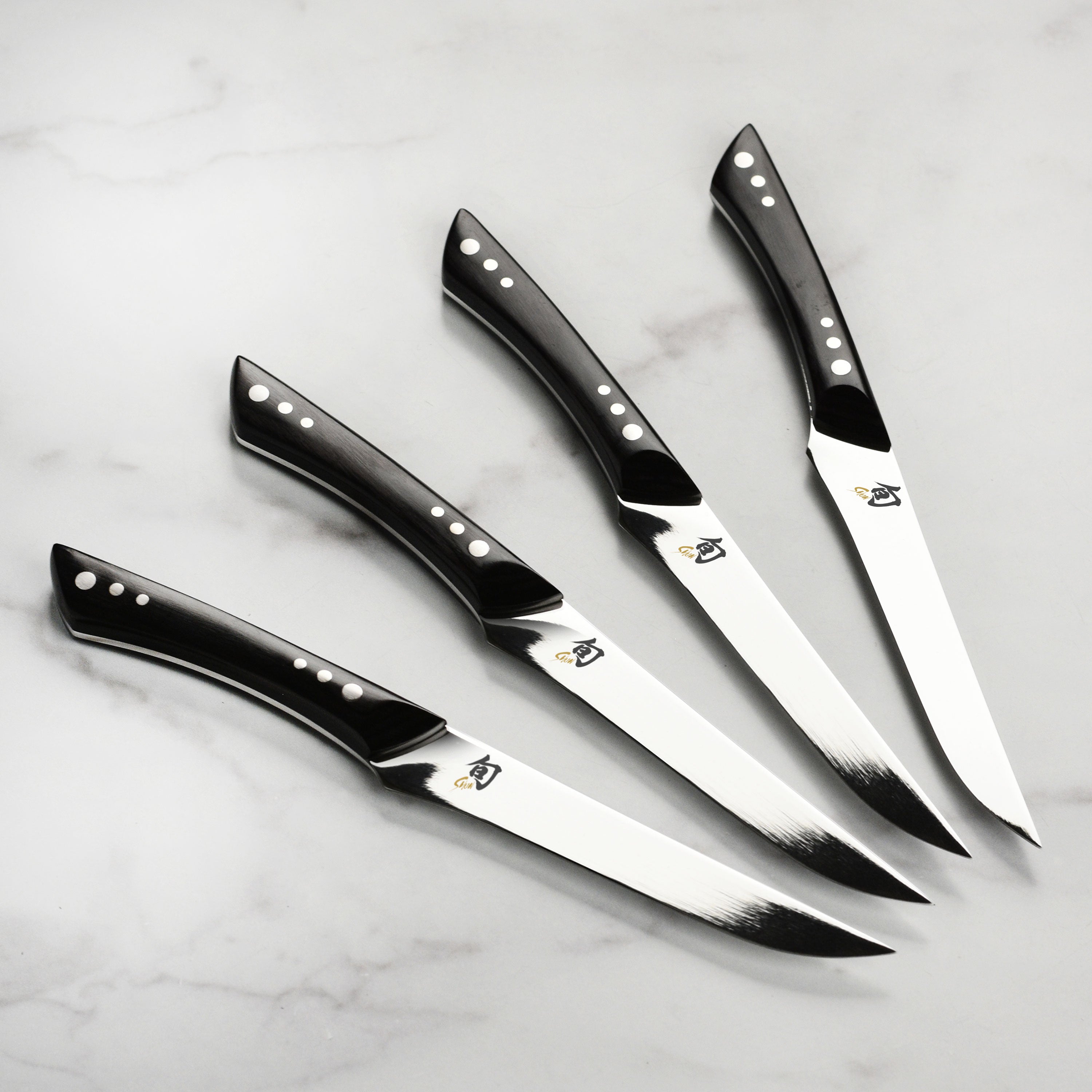 Japanese steak knives with black Pakkawood handles and sharp blades for effortless slicing