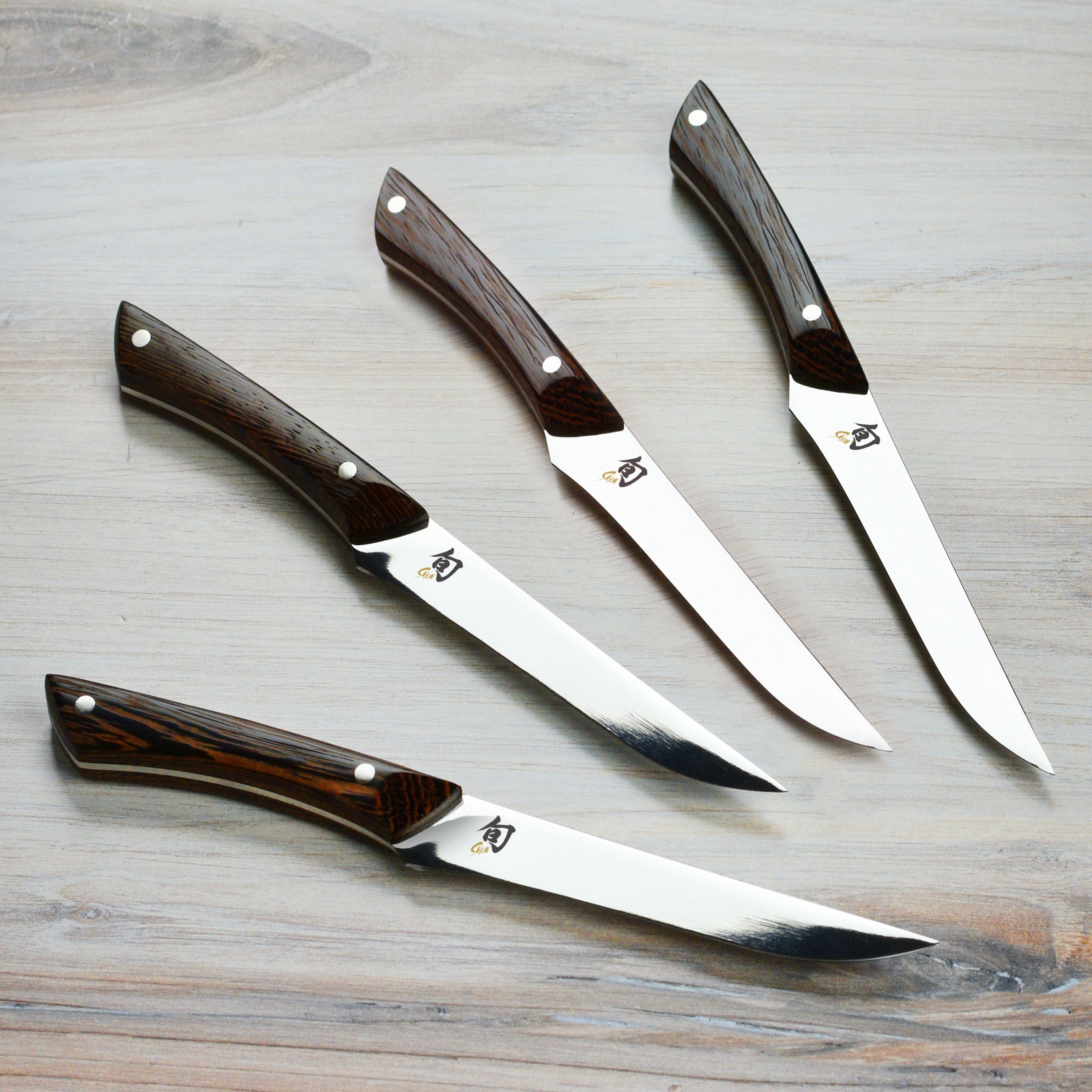 Close-up of the high-carbon blade of the premium Japanese steak knife set, highlighting its sharp edge.
