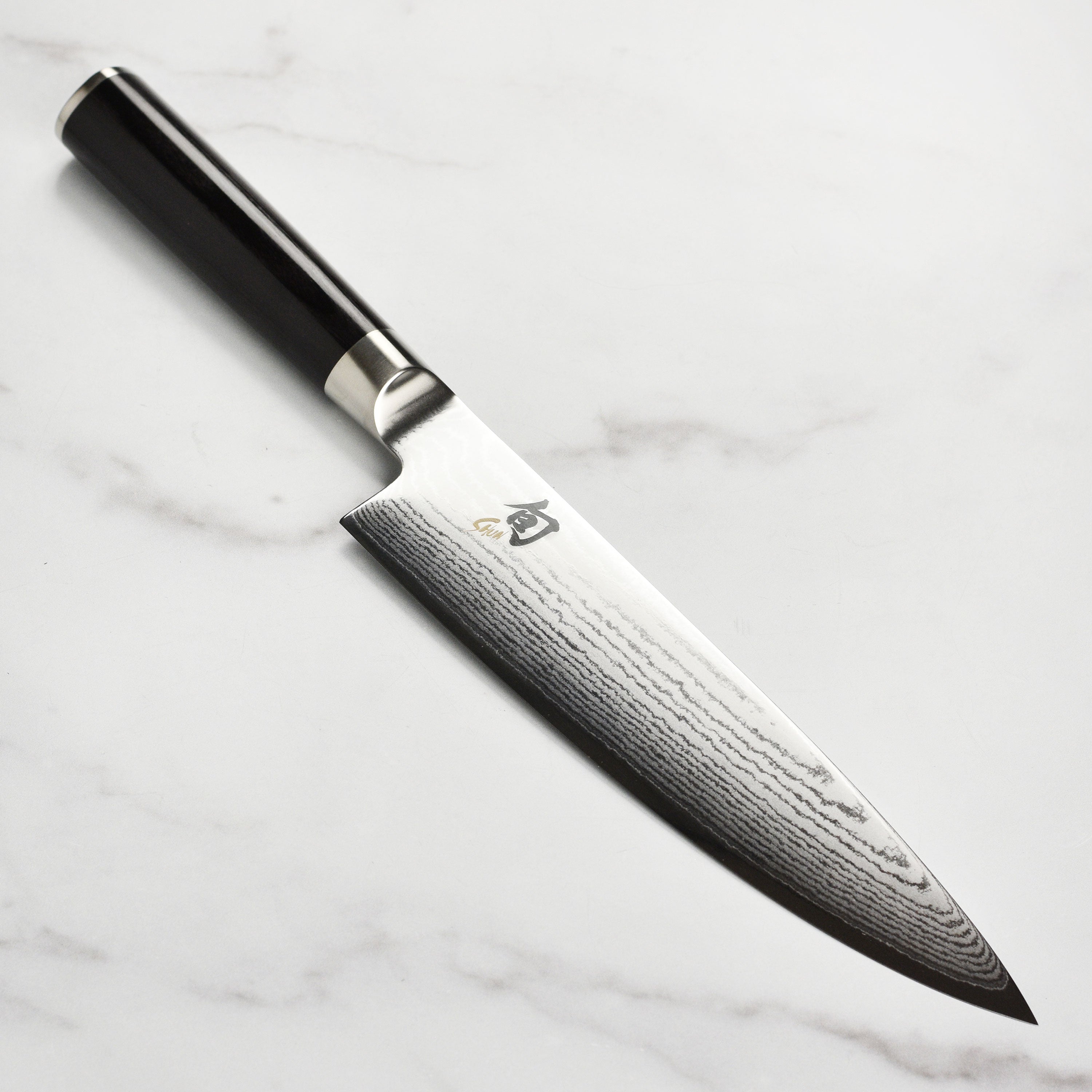 Side view of the Damascus knife highlighting its beautiful blade and handle.