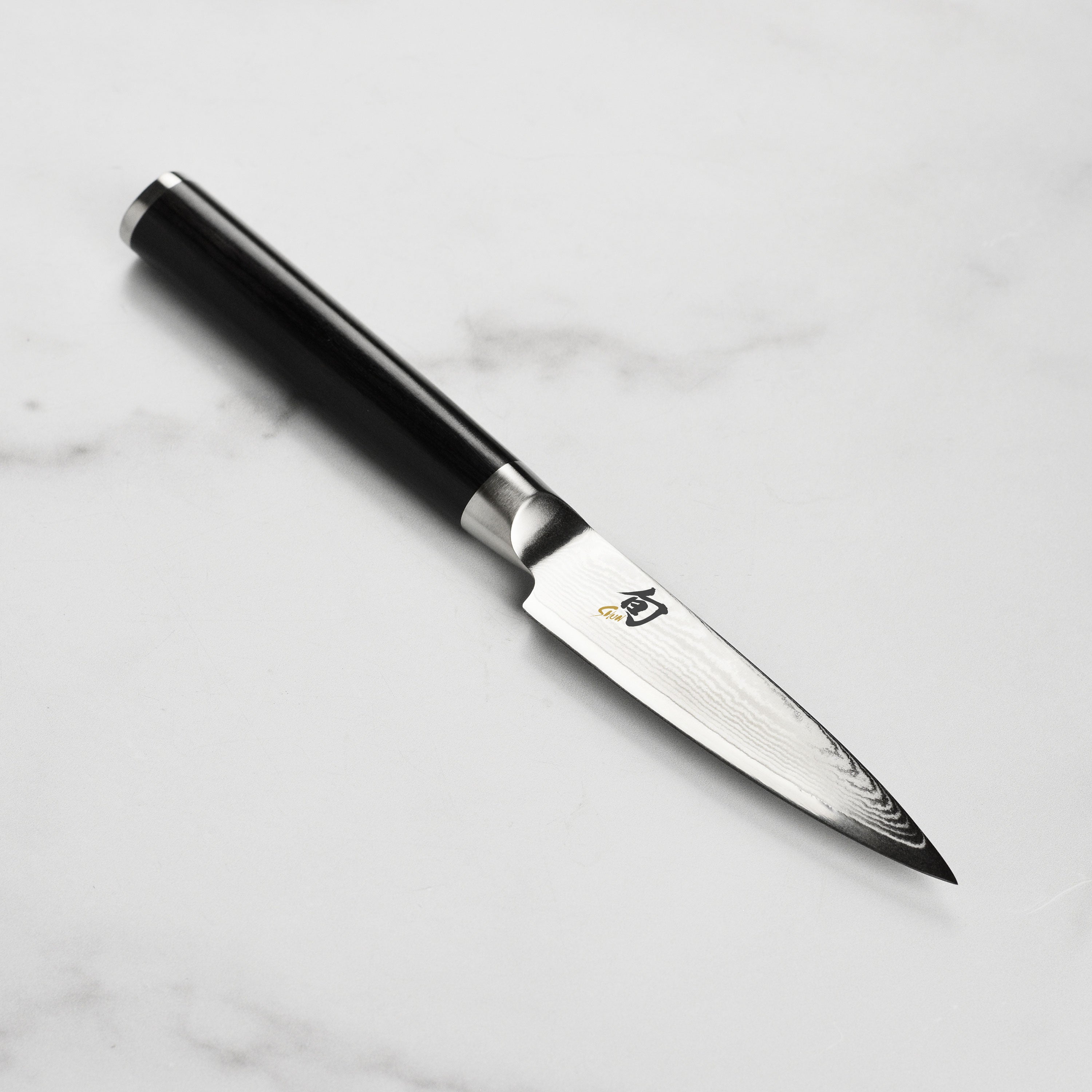 Close-up of the Shun Classic paring knife blade demonstrating its sharpness and craftsmanship.