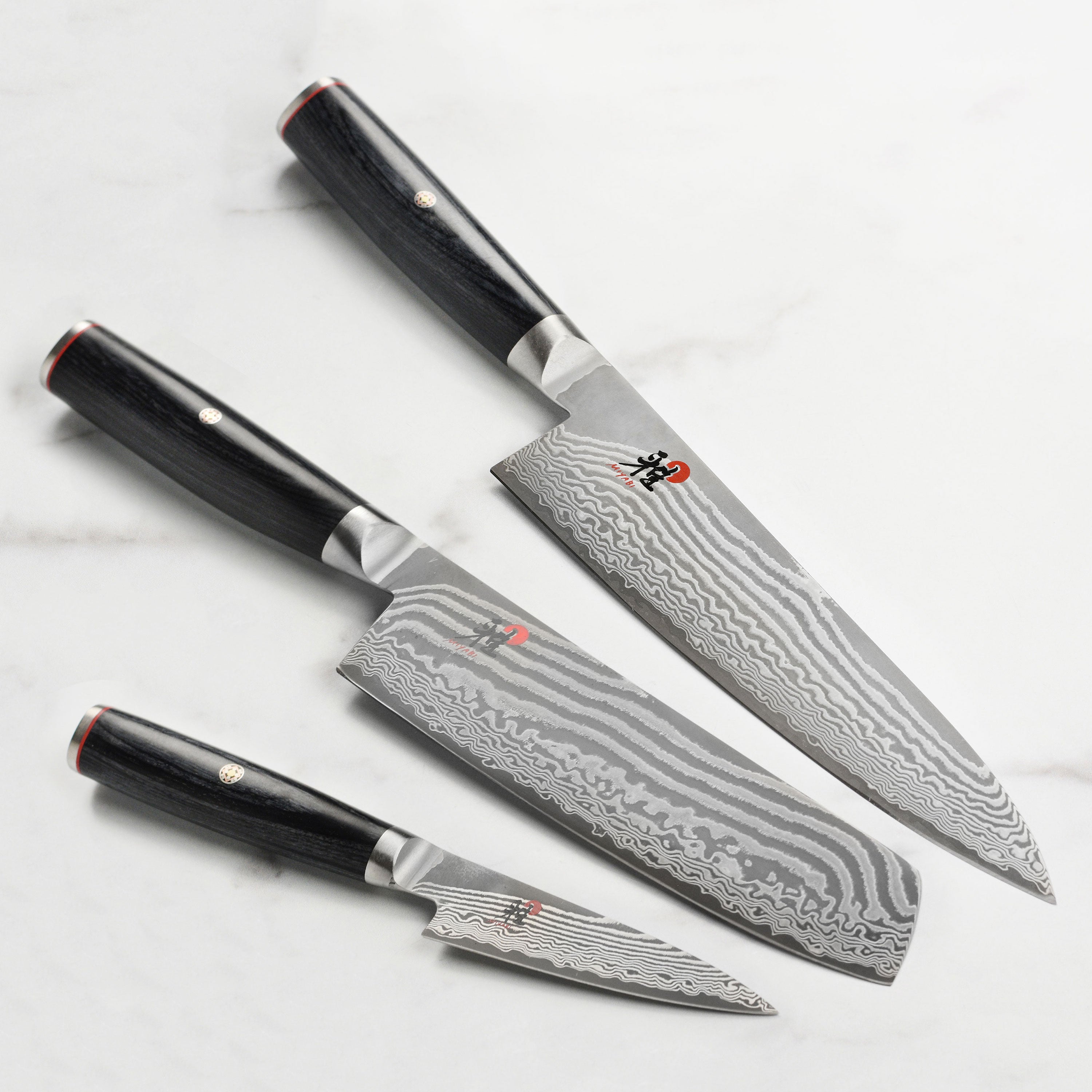 Miyabi Kaizen II 3-piece knife set showcasing the Damascus pattern and Pakkawood handle.