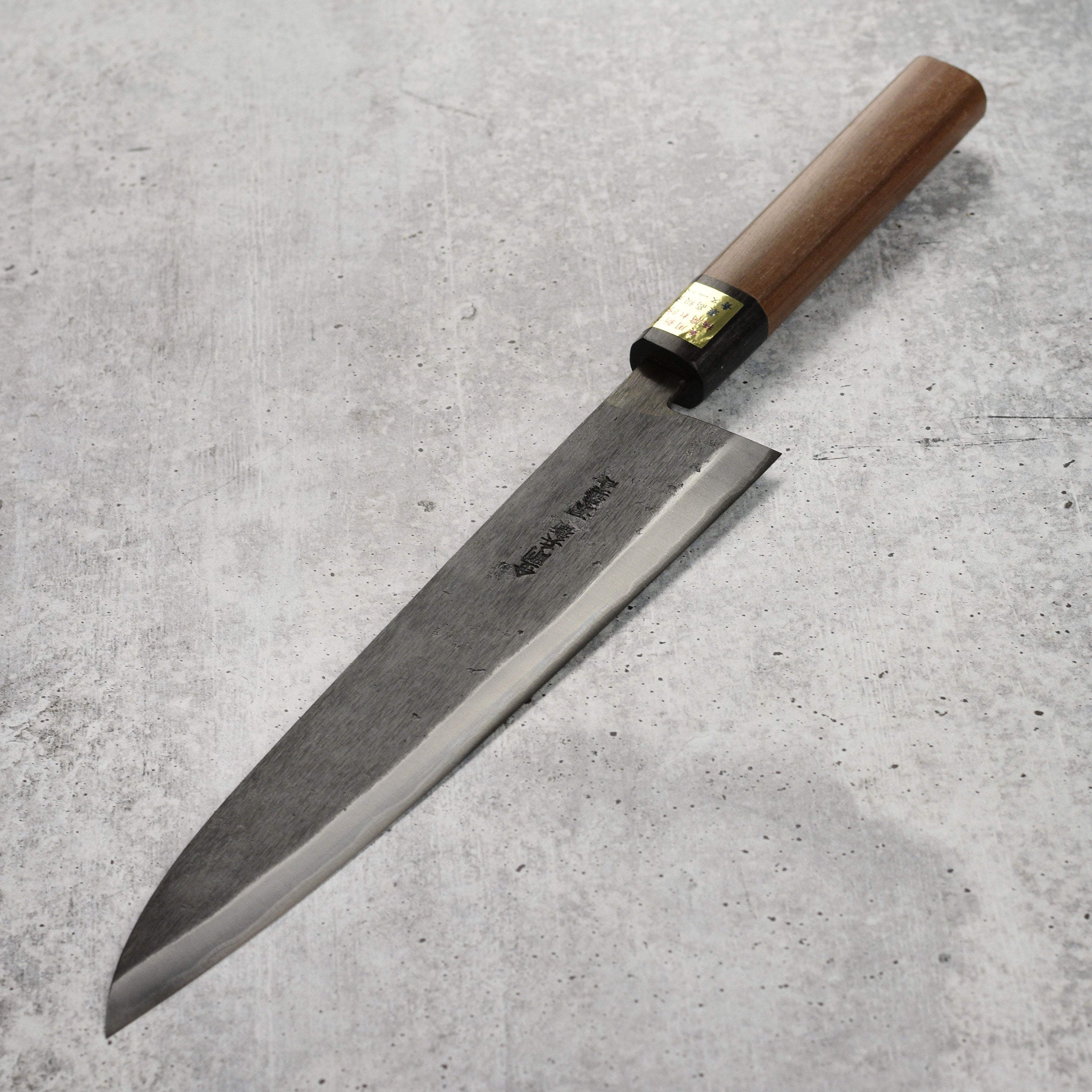 Close-up of Moritaka gyuto blade showing sharp edge and craftsmanship