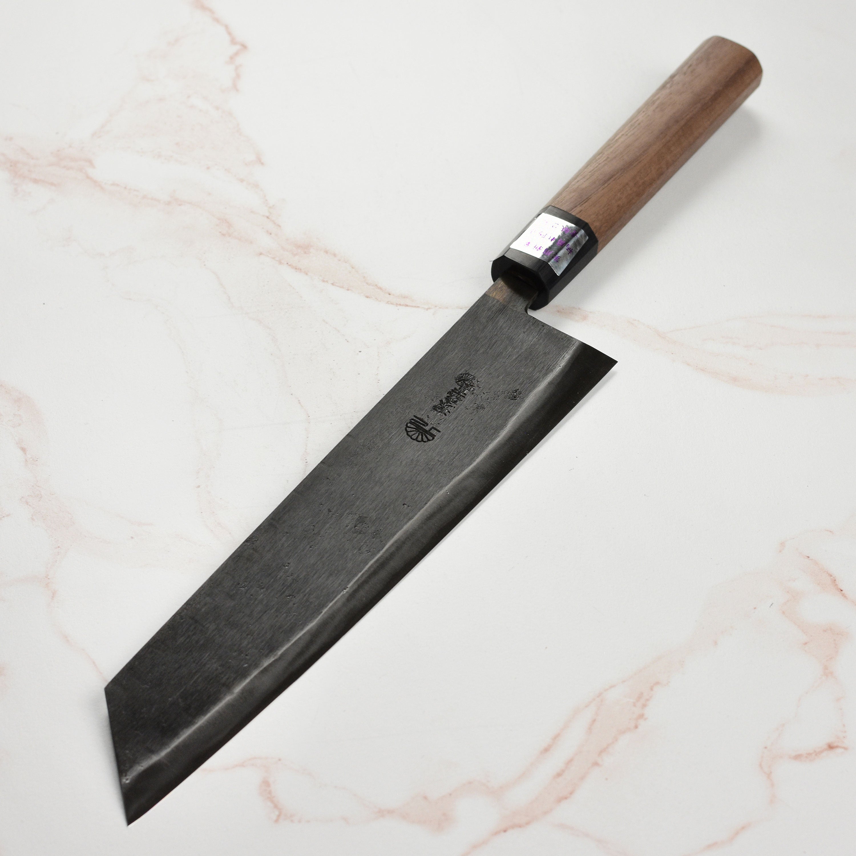 Moritaka Aogami #2 knife showcasing the elegant walnut wood handle and sharp blade from a side angle.