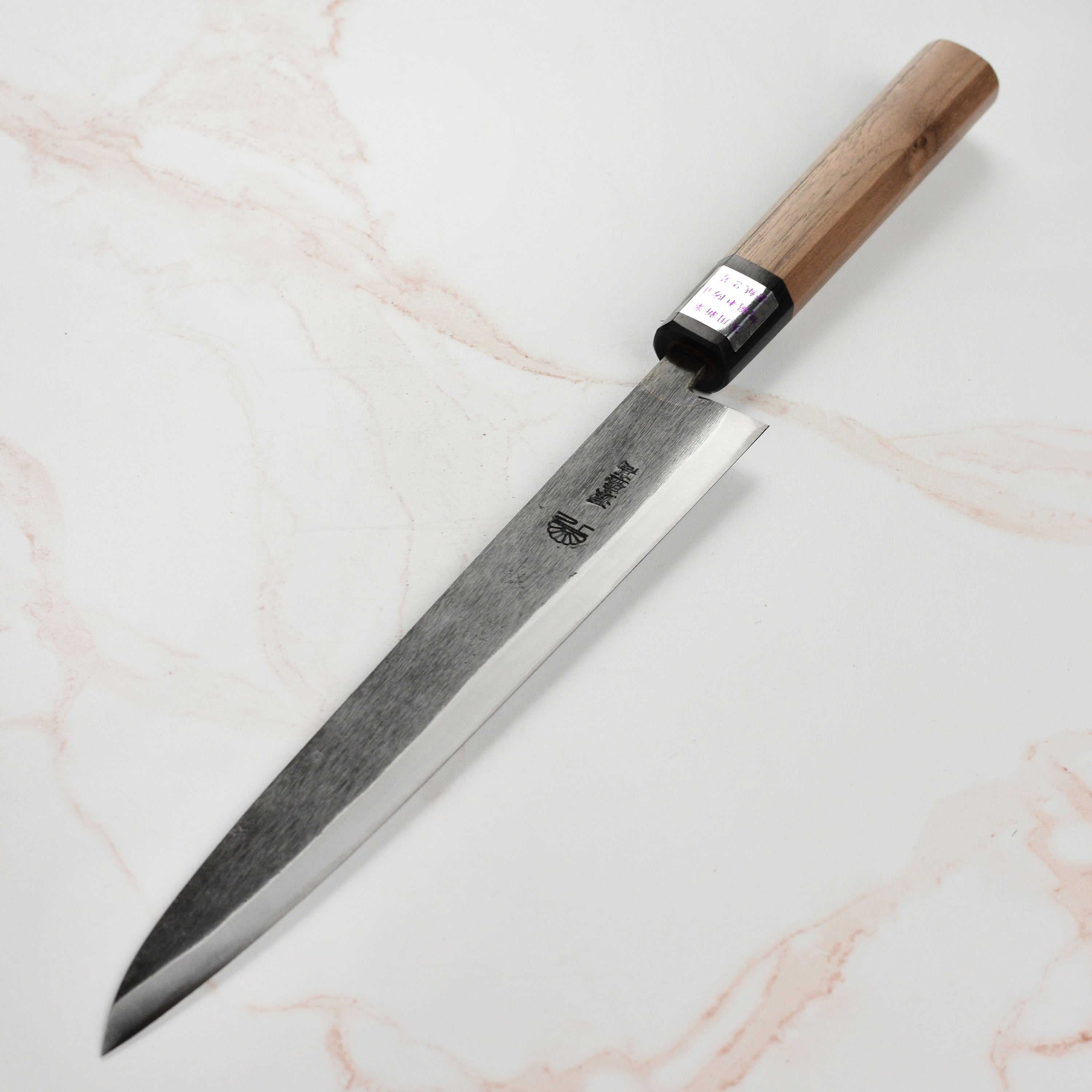 Close-up of Moritaka 9.4-inch Aogami #2 carbon steel sujihiki blade showcasing sharp edge and craftsmanship