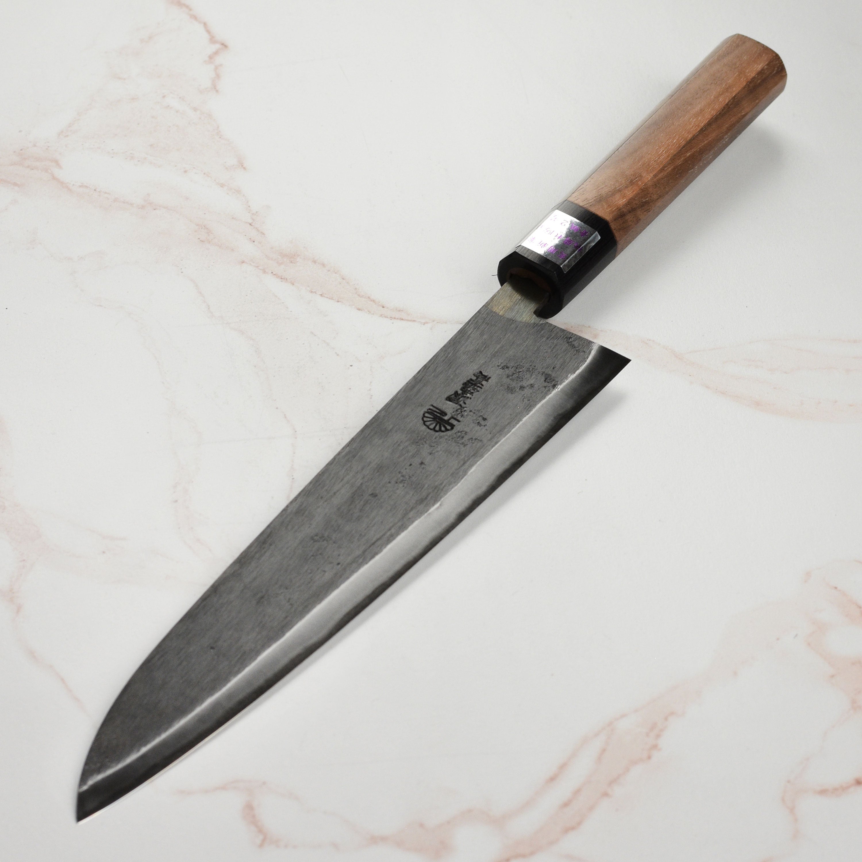 Moritaka 9.4 inch gyuto knife, showcasing the elegant walnut wood handle and sharp Aogami Blue #2 carbon steel blade.