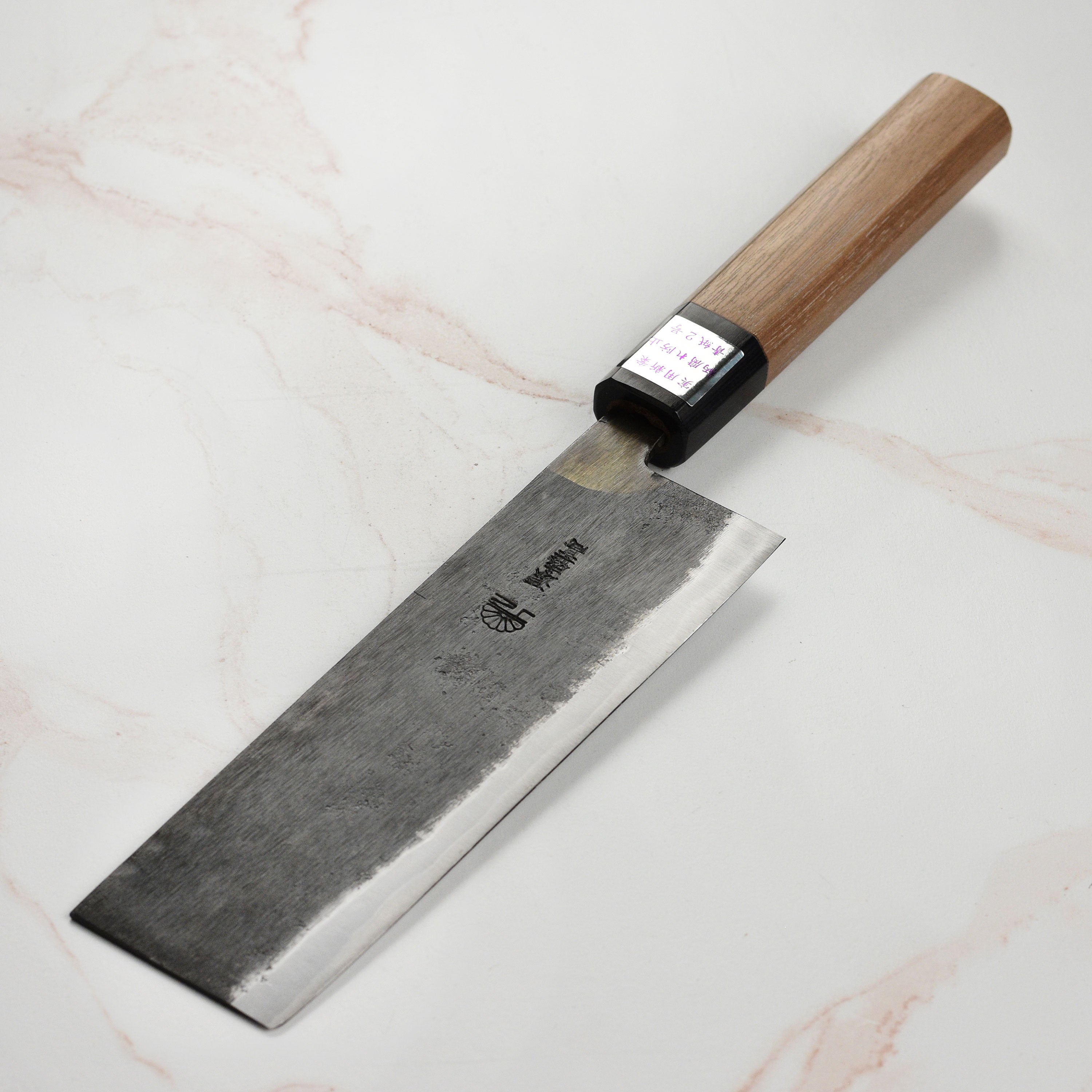 Moritaka Aogami #2 Nakiri knife displayed on a wooden cutting board, highlighting its sharp blade and elegant handle.