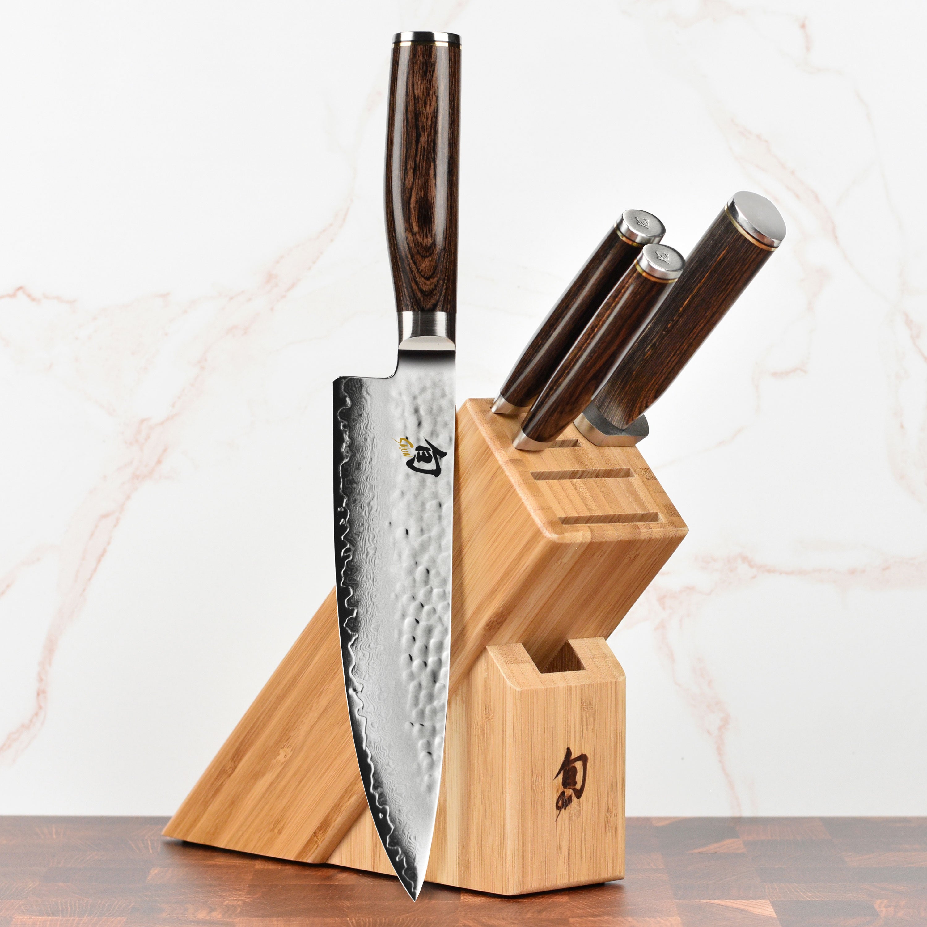 Close-up of the Shun Premier Japanese knives with Damascus layered blades and walnut handles