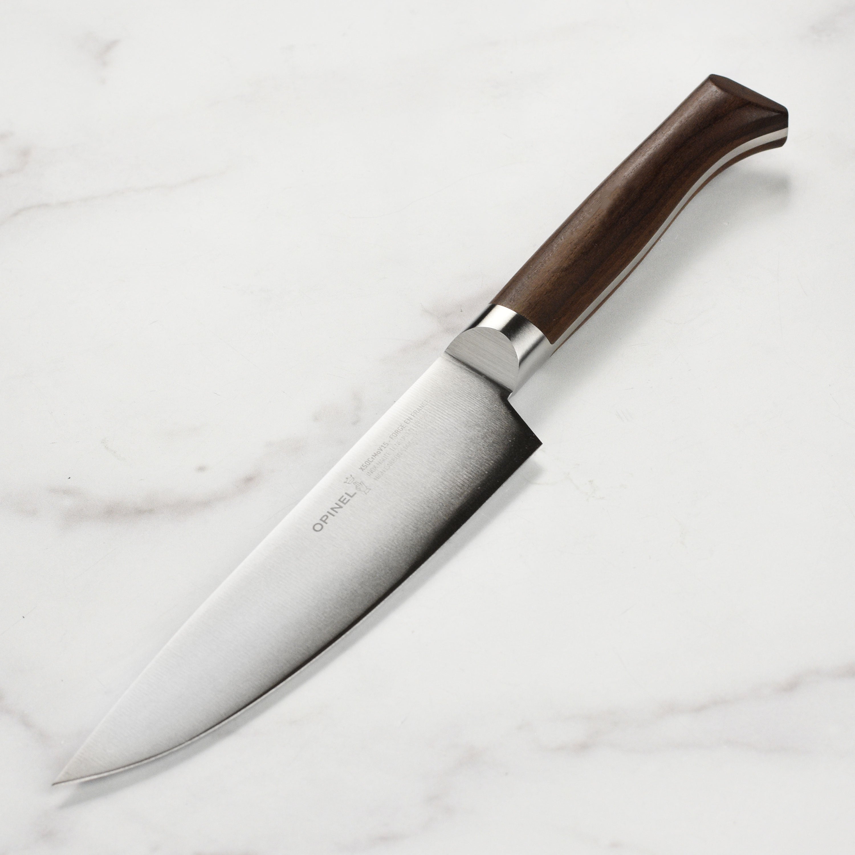 Opinel 1890 forged chef's knife showcasing the full tang design and beech wood handle.