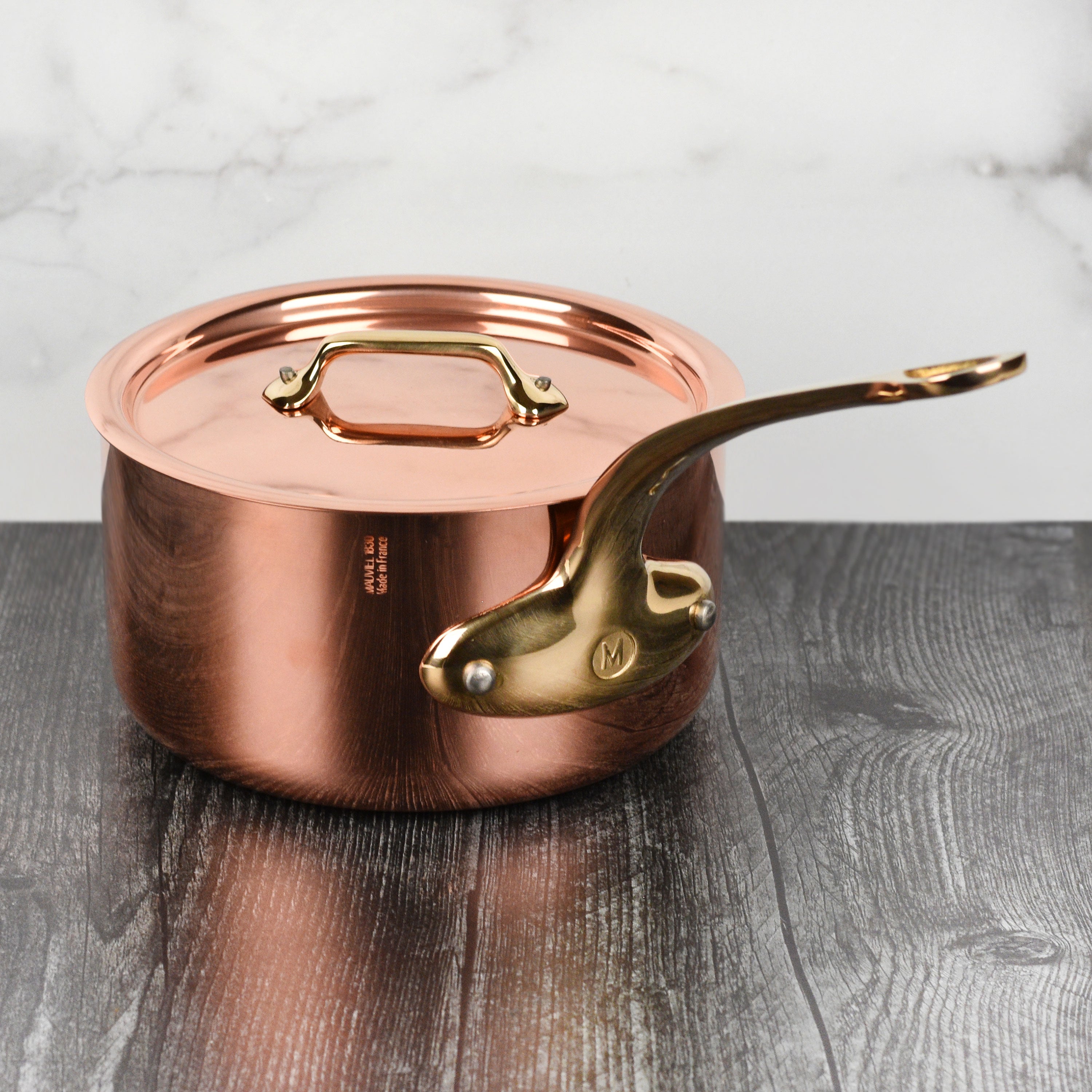 Close-up of the Mauviel M200B copper saucepan showing its copper exterior and stainless steel handle