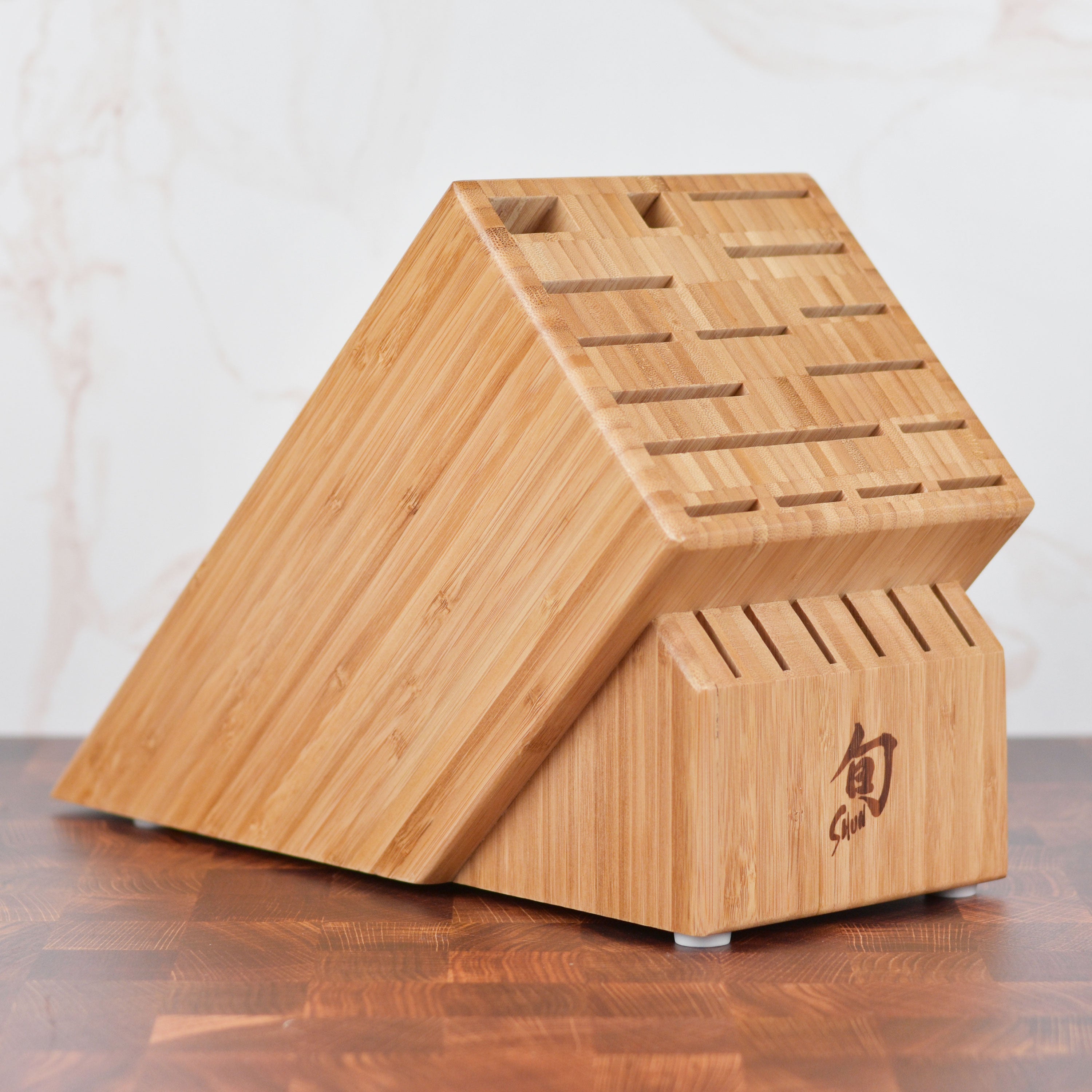 Angled view of the Premium Bamboo Knife Block showcasing 22 slots filled with knives.