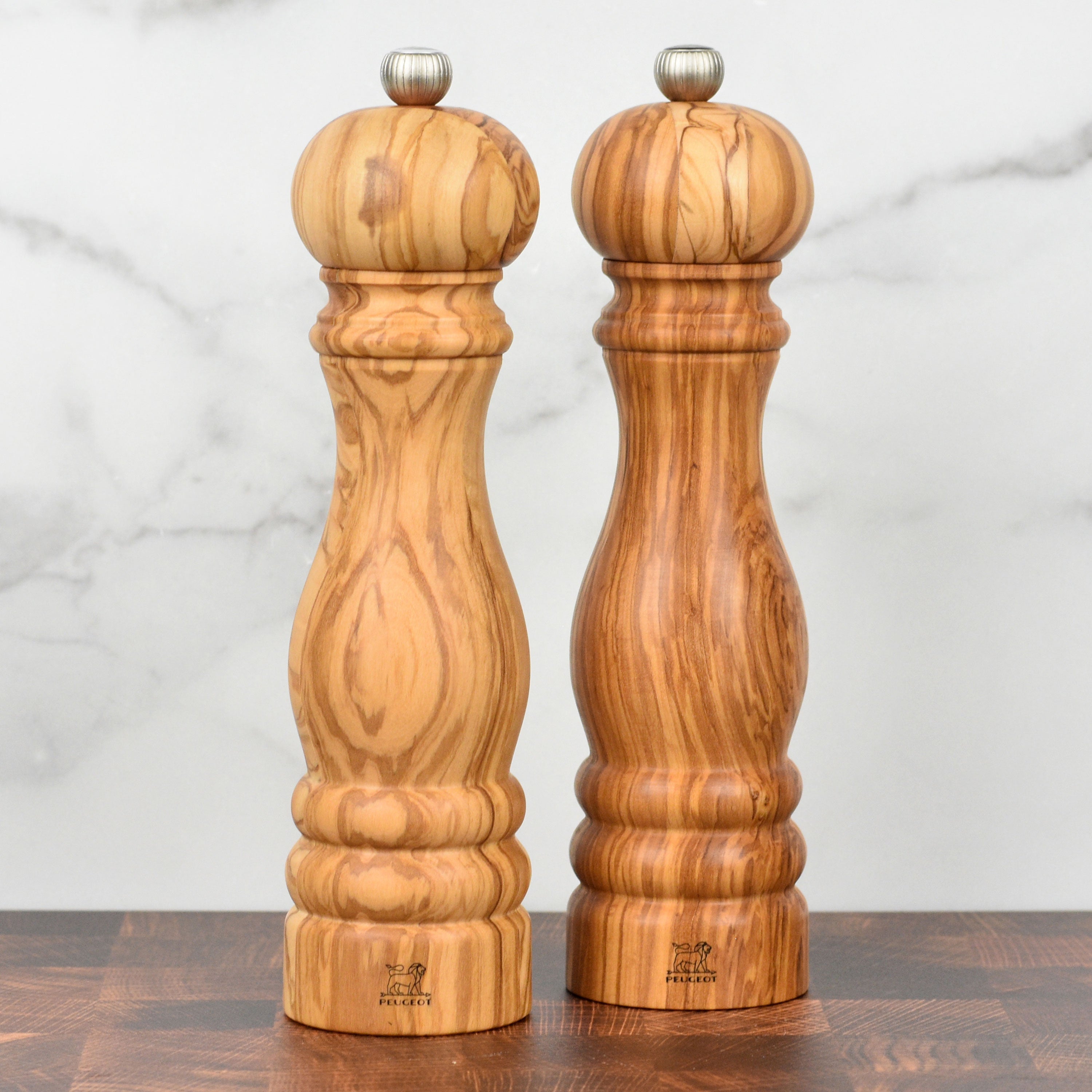 Peugeot Paris Olivewood Salt Mill from a side angle, showcasing its elegant design and smooth finish.