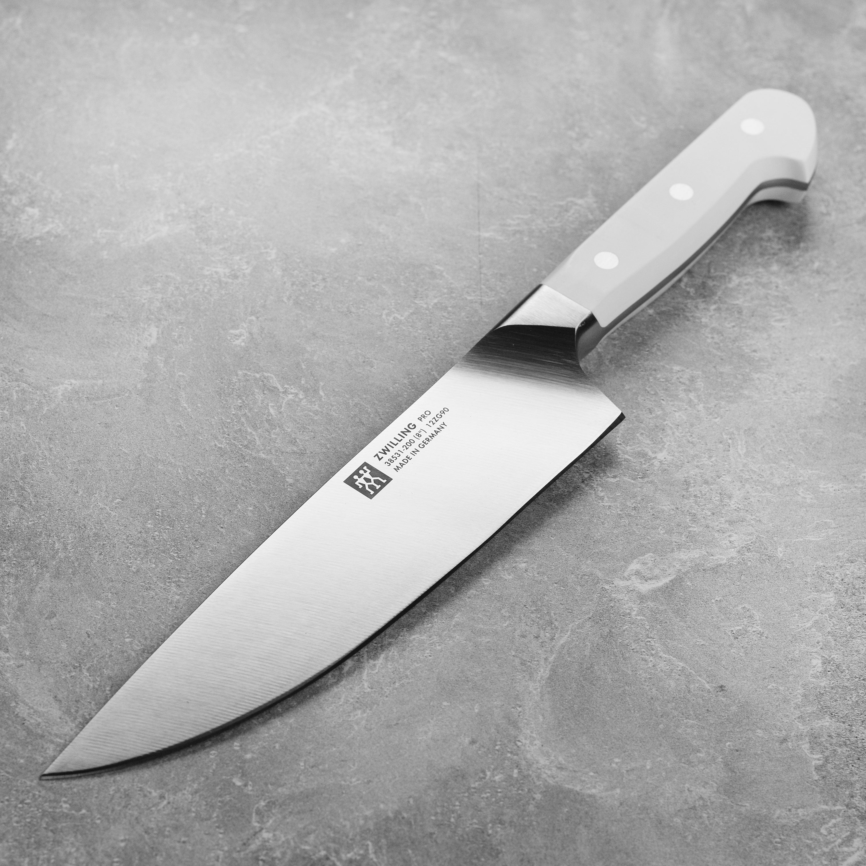 Close-up view of Zwilling Pro Elite chef's knife highlighting the high carbon steel blade.