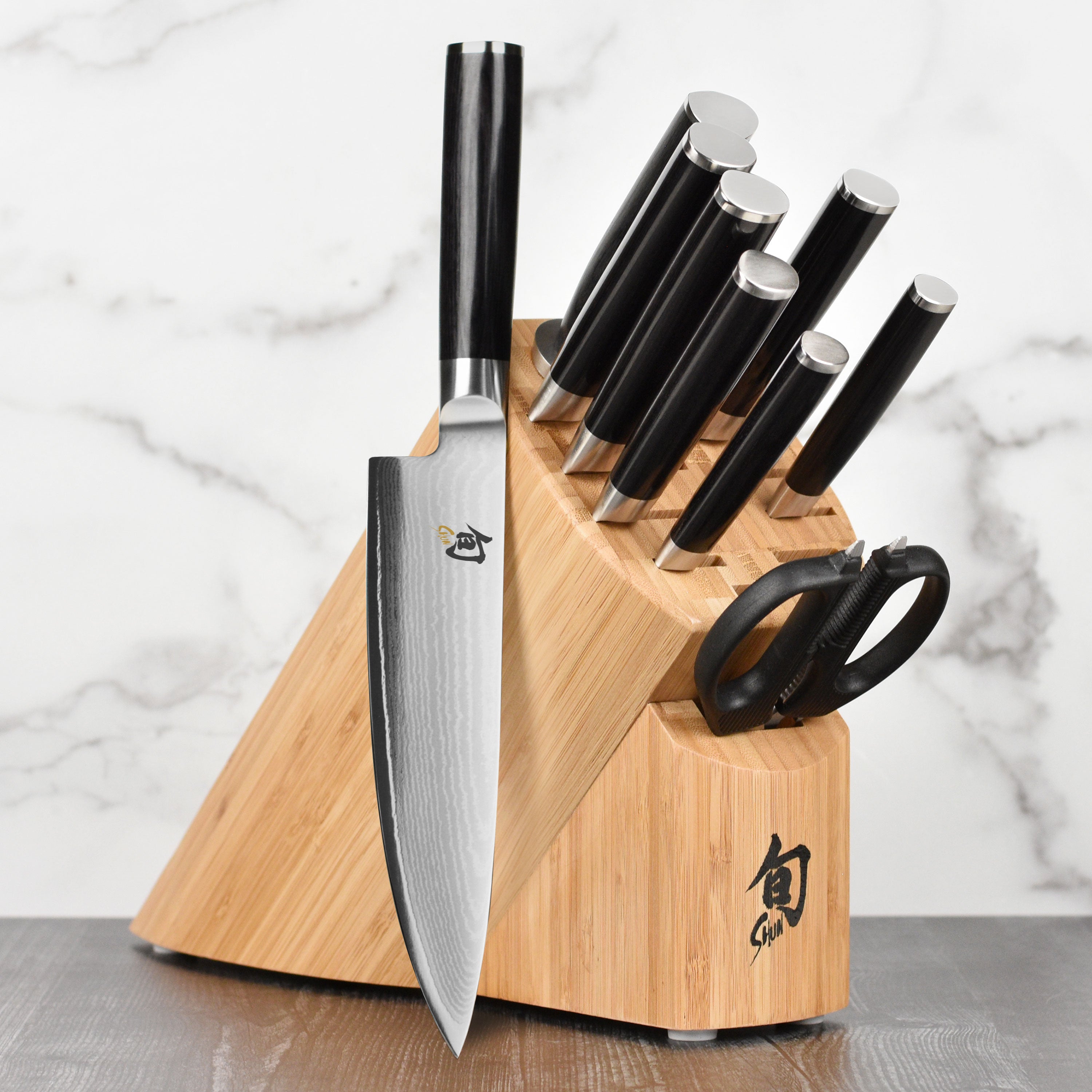 Shun Classic 10-Piece Japanese Knife Set displayed in a kitchen setting, highlighting the elegant D-shaped ebony handle.