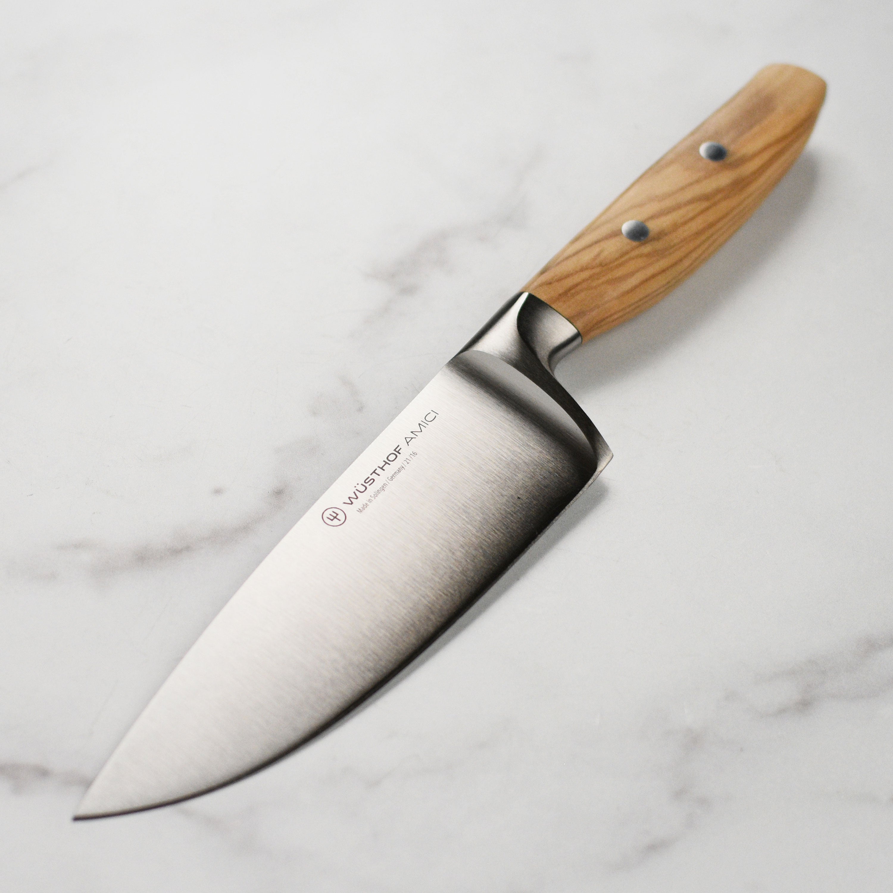 Wusthof Amici 6-inch chef's knife with sharp blade and olive wood handle, ideal for professional and home kitchens