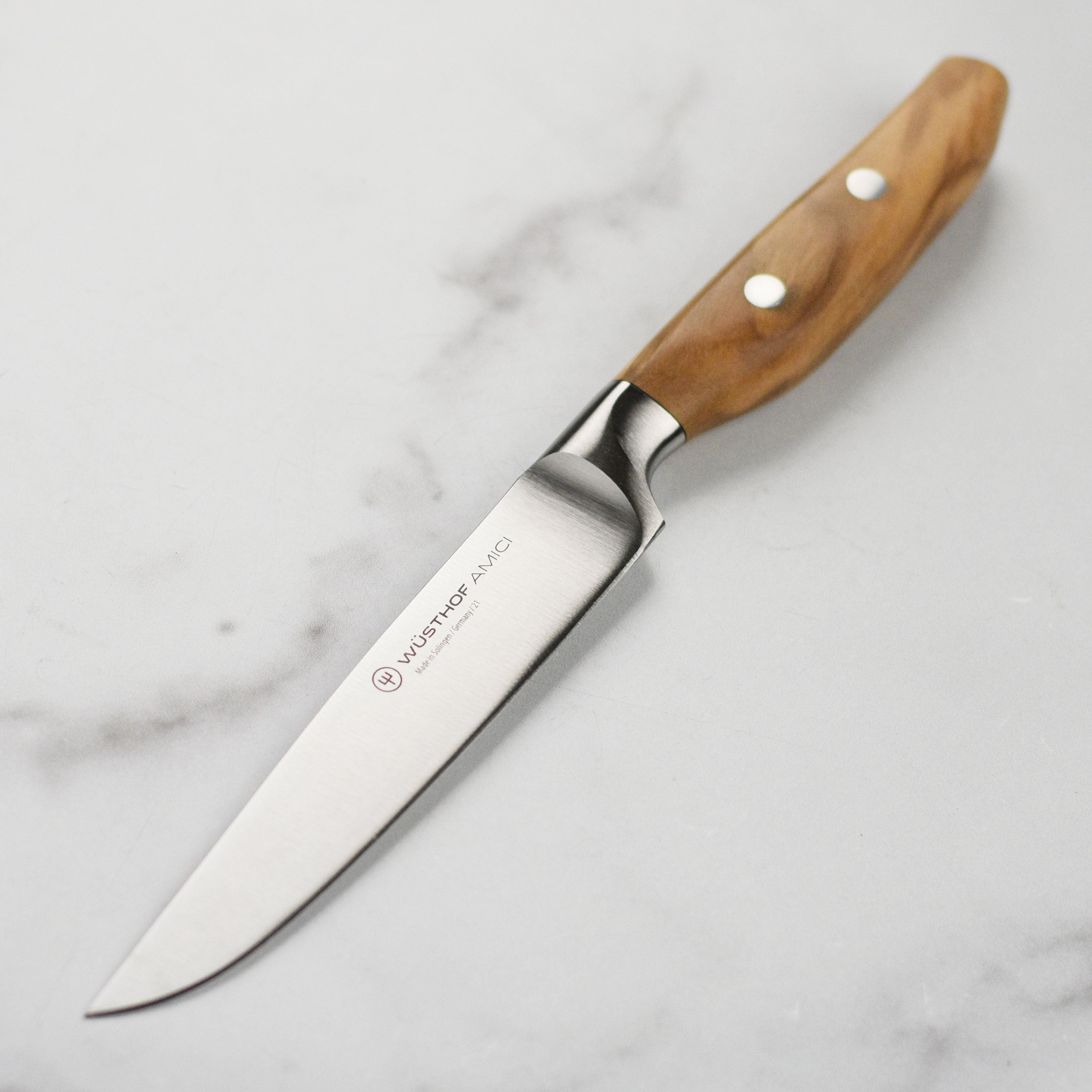 Wusthof Amici 4.5-inch steak knife with high-carbon steel blade and olive wood handle for precise cutting