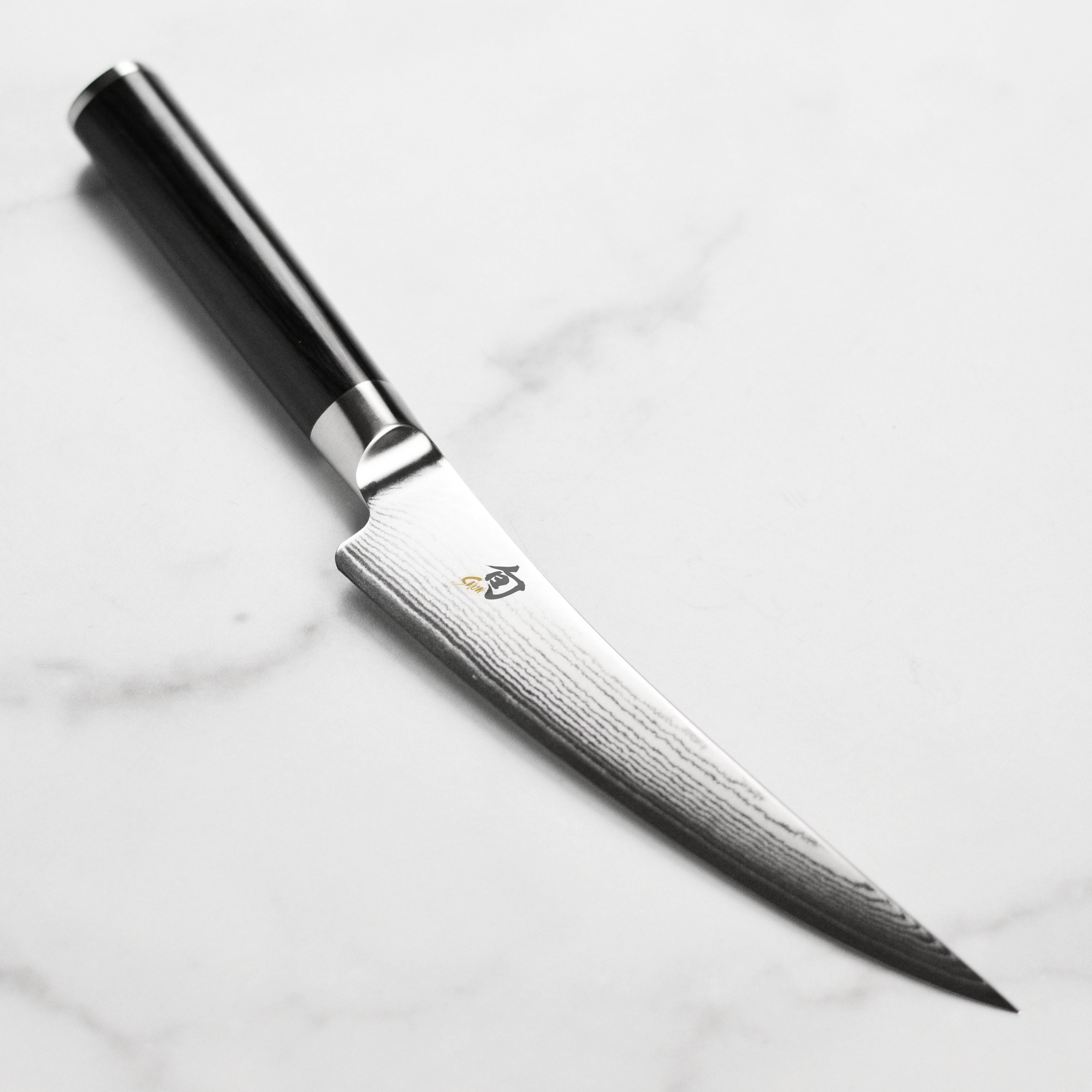 Close-up view of the Shun Classic Gokujo 6-Inch Boning and Fillet Knife highlighting the blade