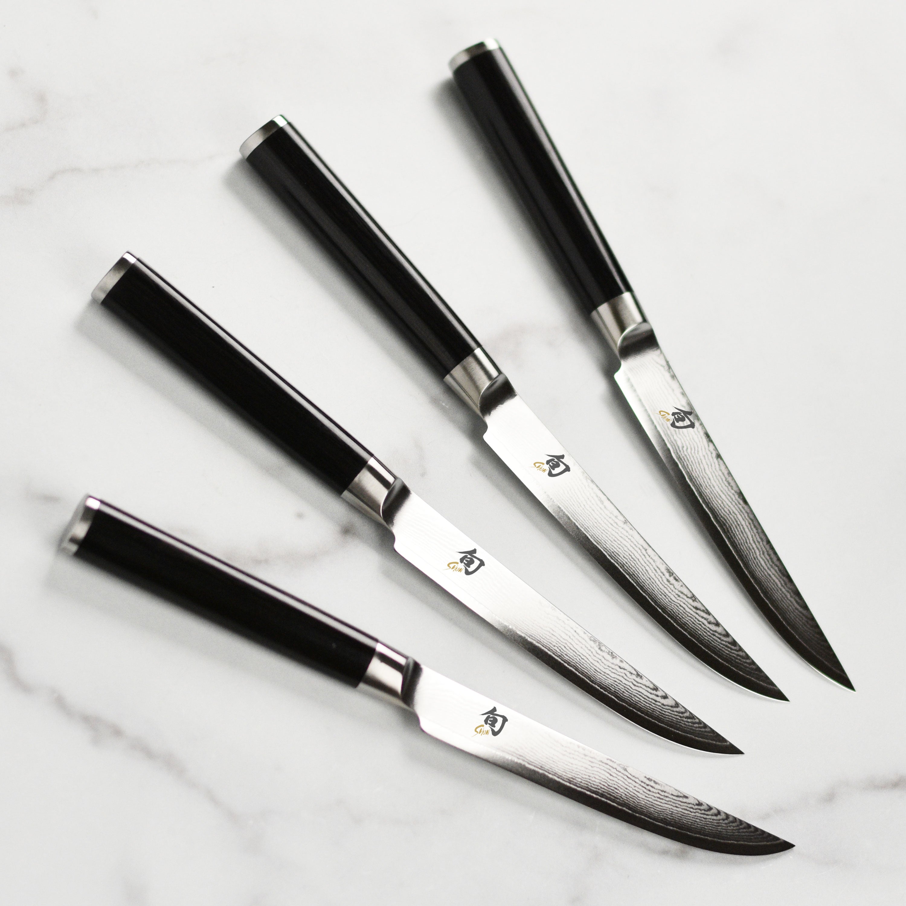 Japanese Damascus steel steak knives with ebony handles for precise slicing