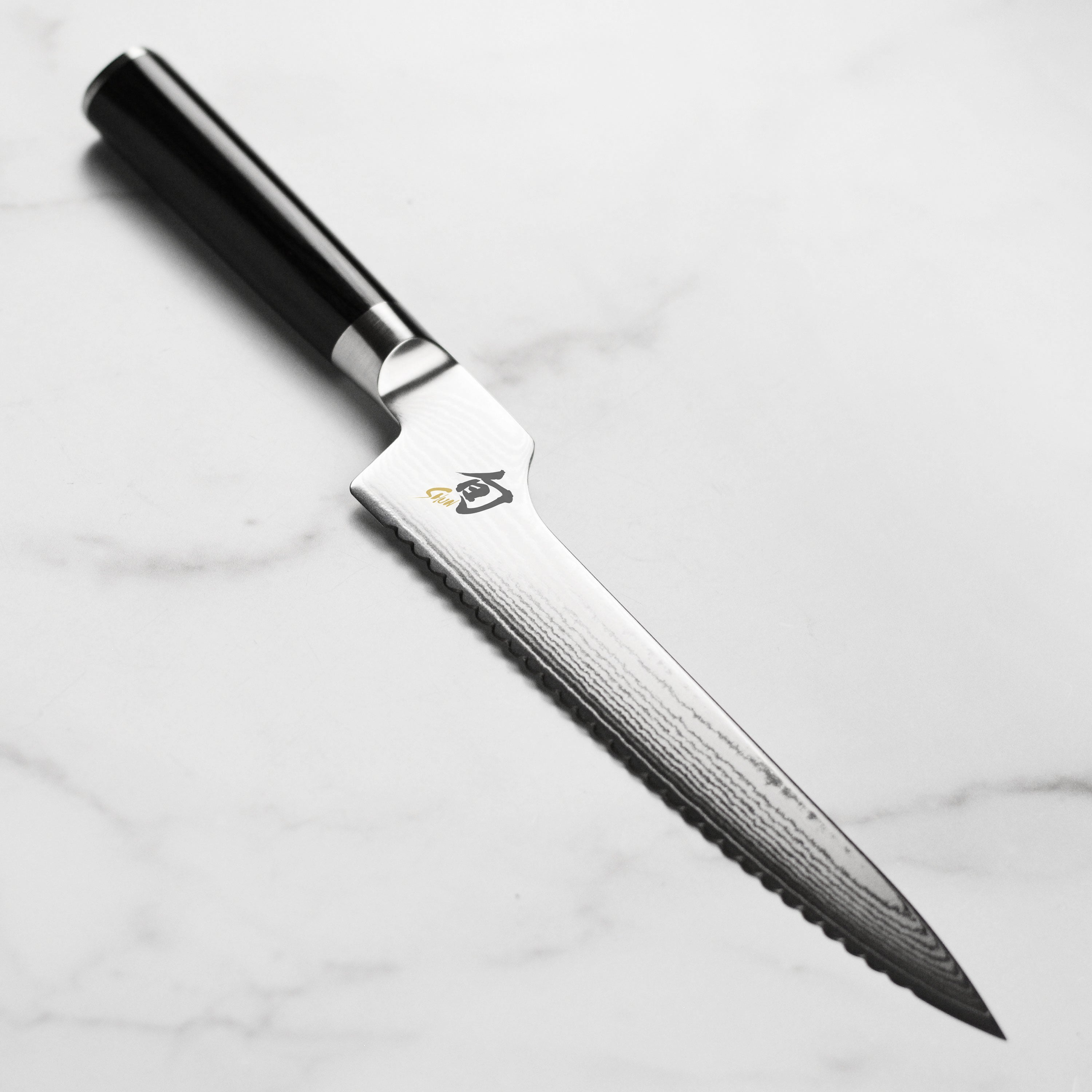 Shun Classic 8-inch offset bread knife with layered Damascus blade and ebony handle