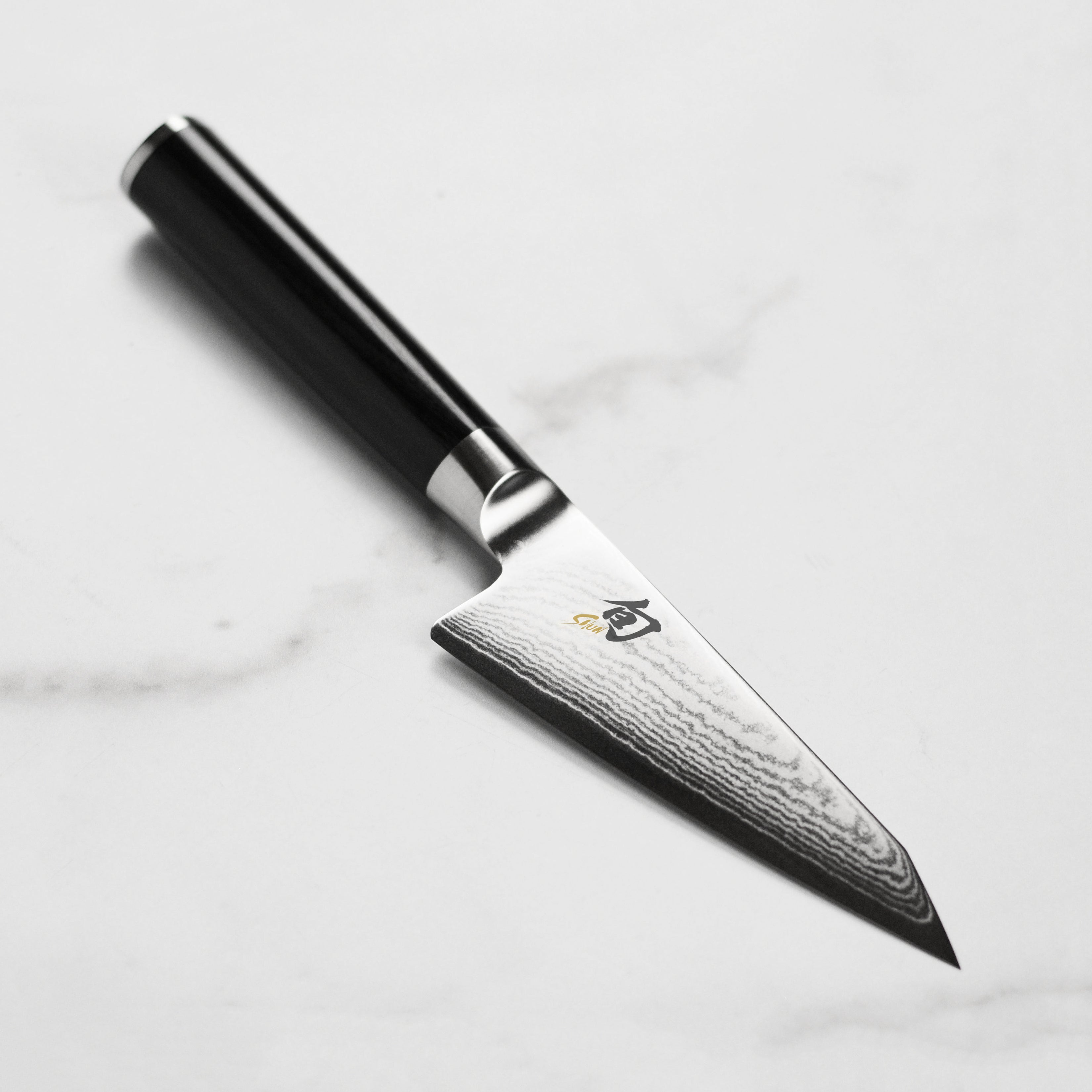 Shun Classic 4.5-inch Honesuki Knife showcasing the elegant Damascus pattern on the blade.