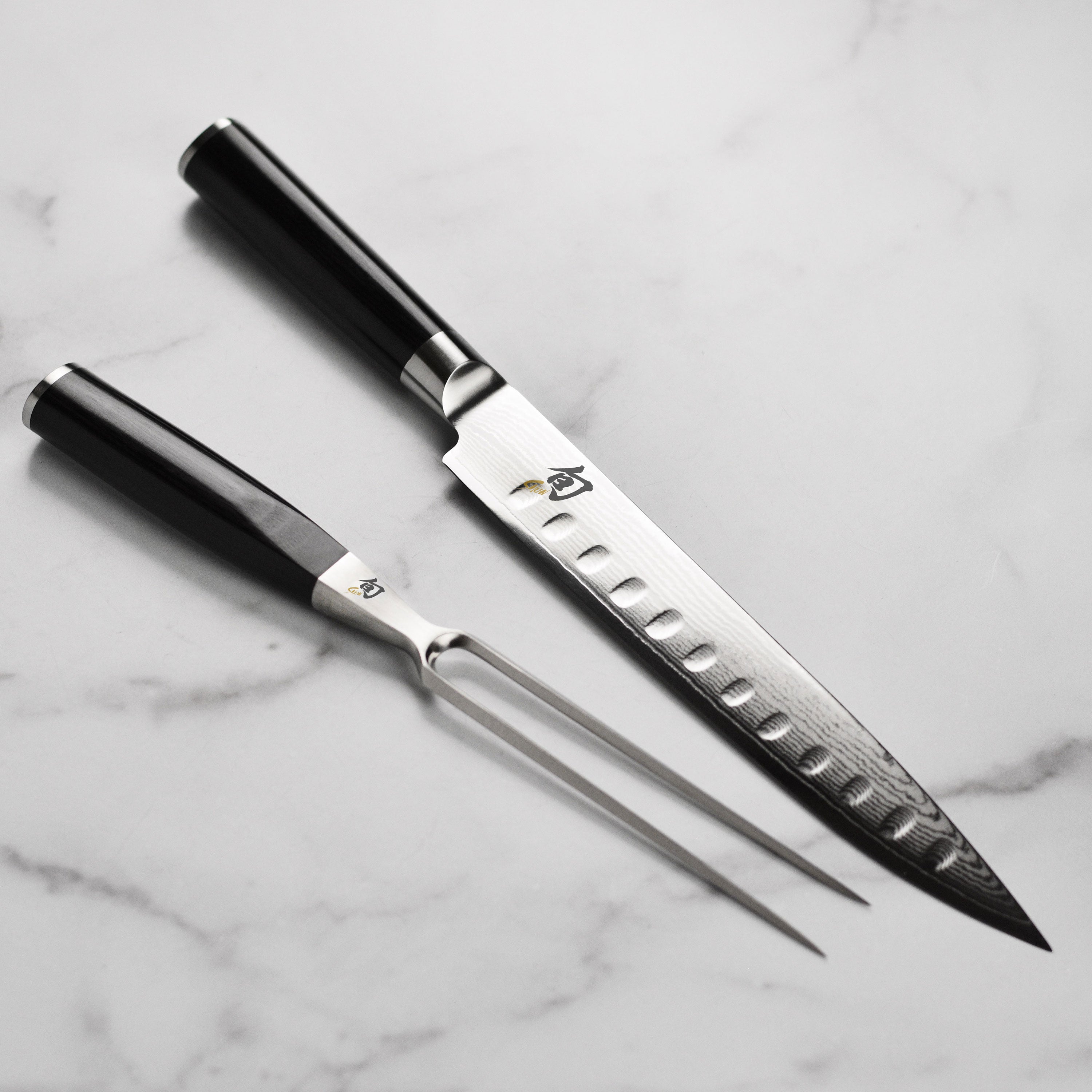 Shun Classic carving knife set showcasing the elegant design and Damascus cladding.