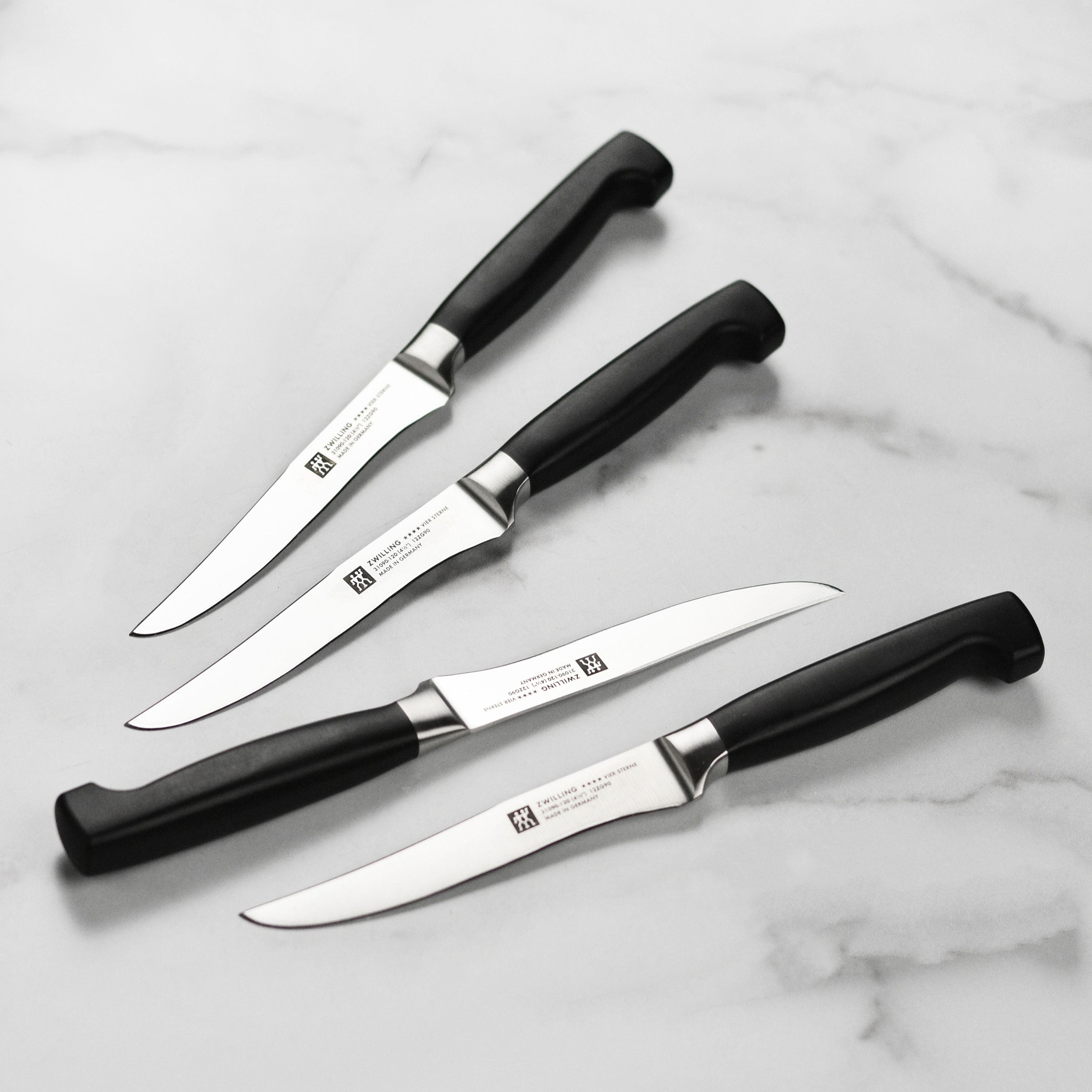 Set of Zwilling Four Star premium steak knives showing sharp blades and ergonomic handles