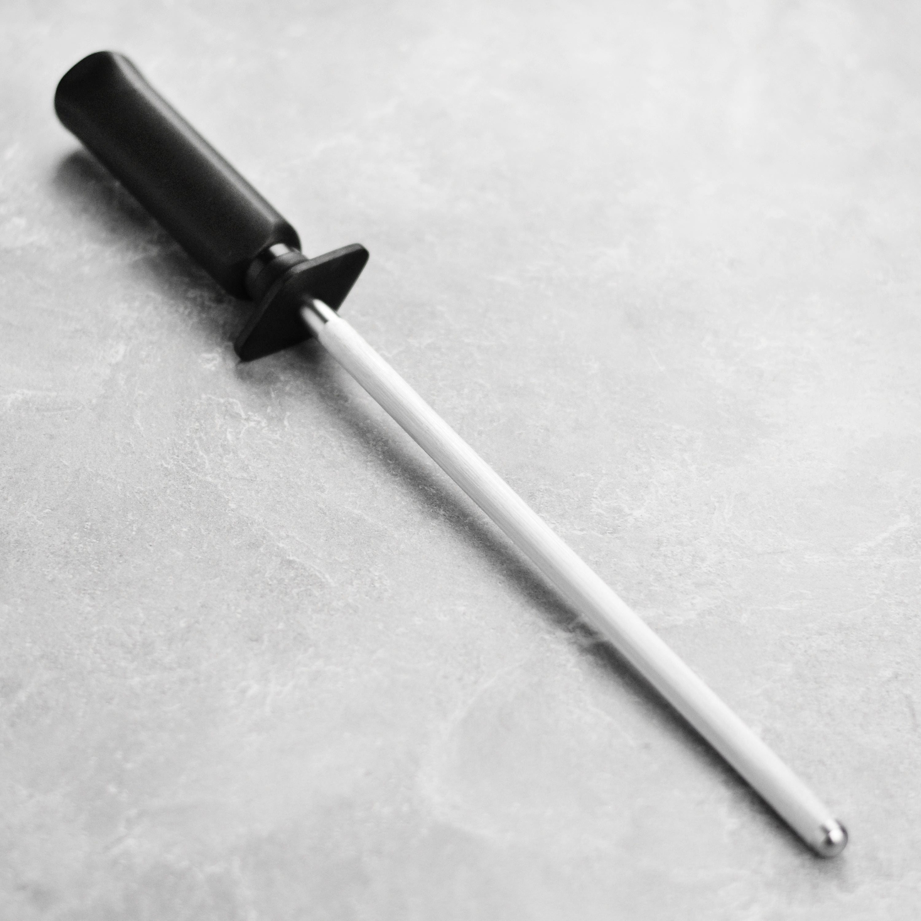 Close-up of Miyabi sharpening steel showing carbon stainless finish and ergonomic handle for precise knife maintenance