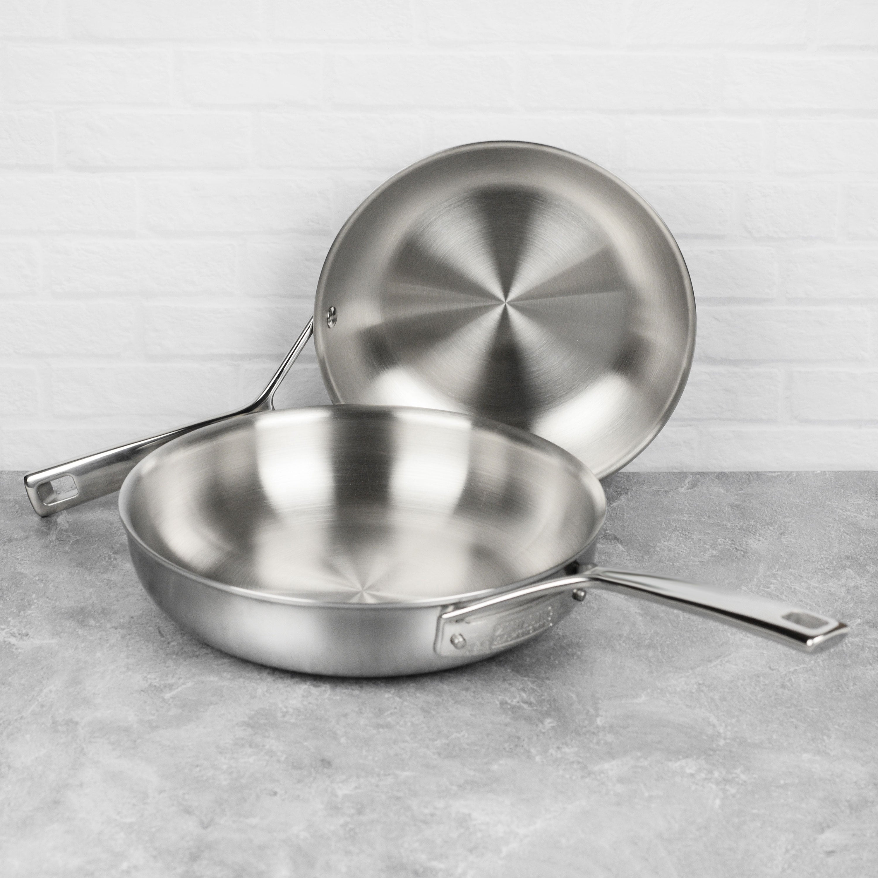 Close-up of Zwilling Aurora fry pan set showing 5-ply construction and ergonomic handle.