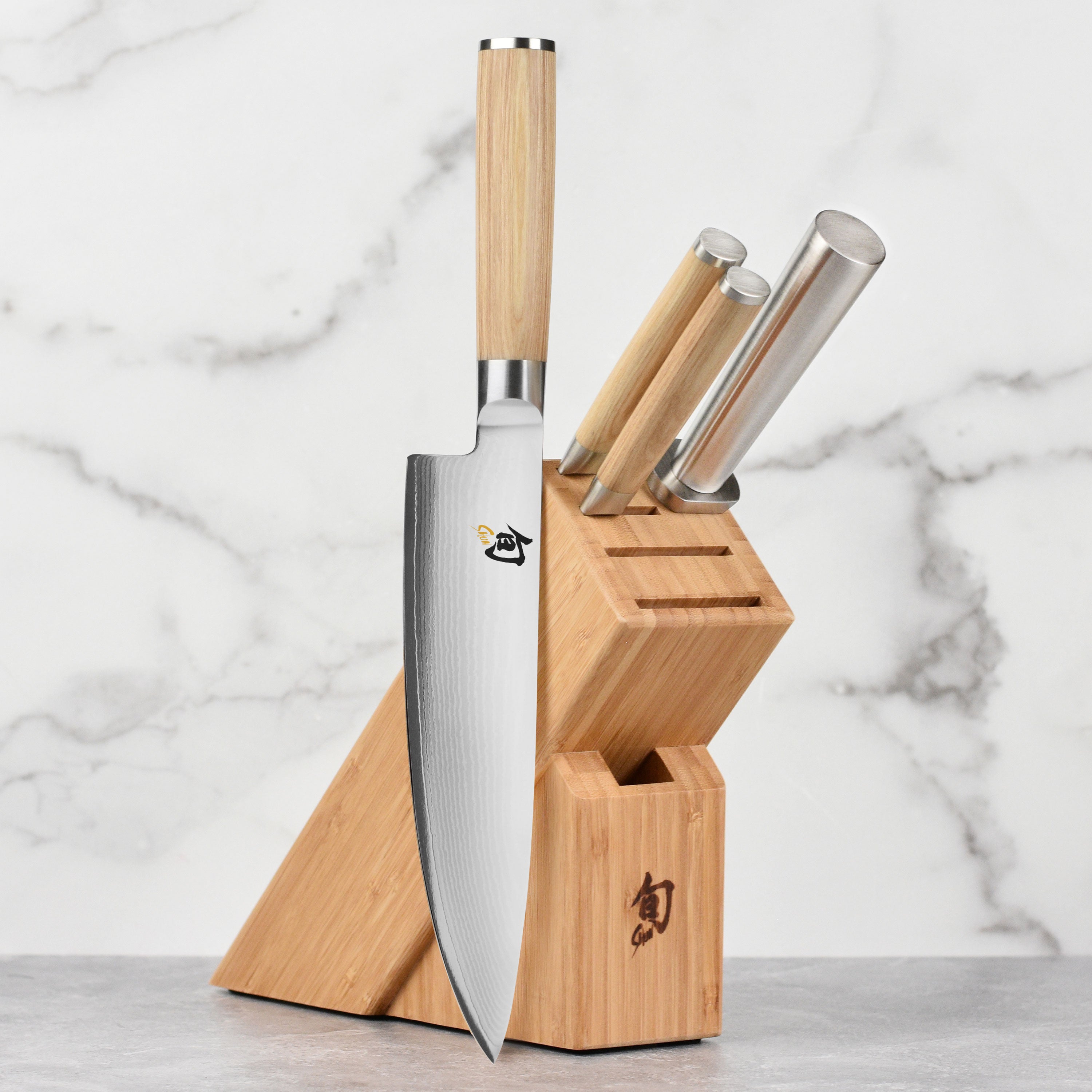 Shun Classic Blonde Knife Set displayed on a wooden cutting board, showcasing its elegant design and craftsmanship.