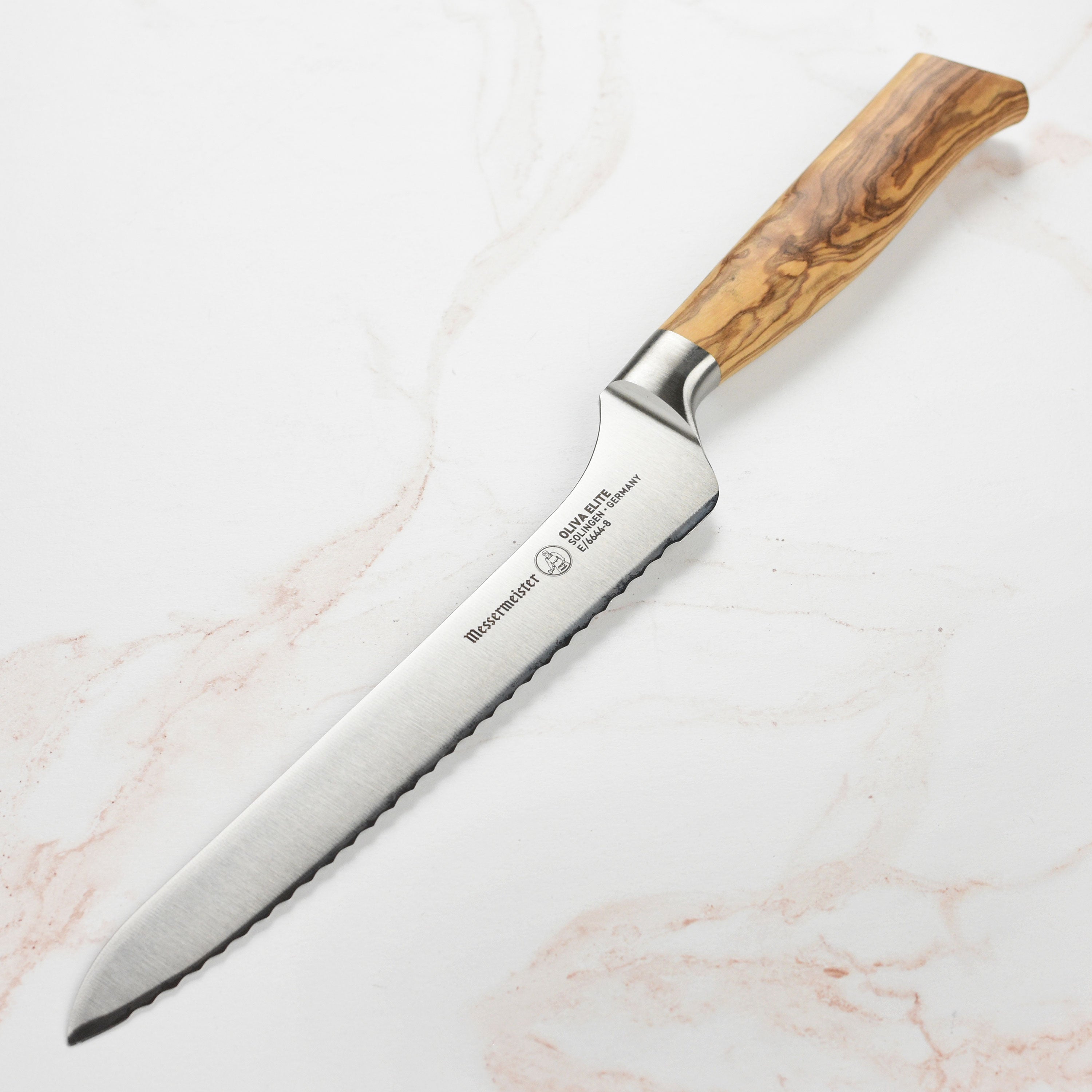 Messermeister Oliva Elite offset bread knife held in hand, illustrating its ergonomic design for comfortable use.