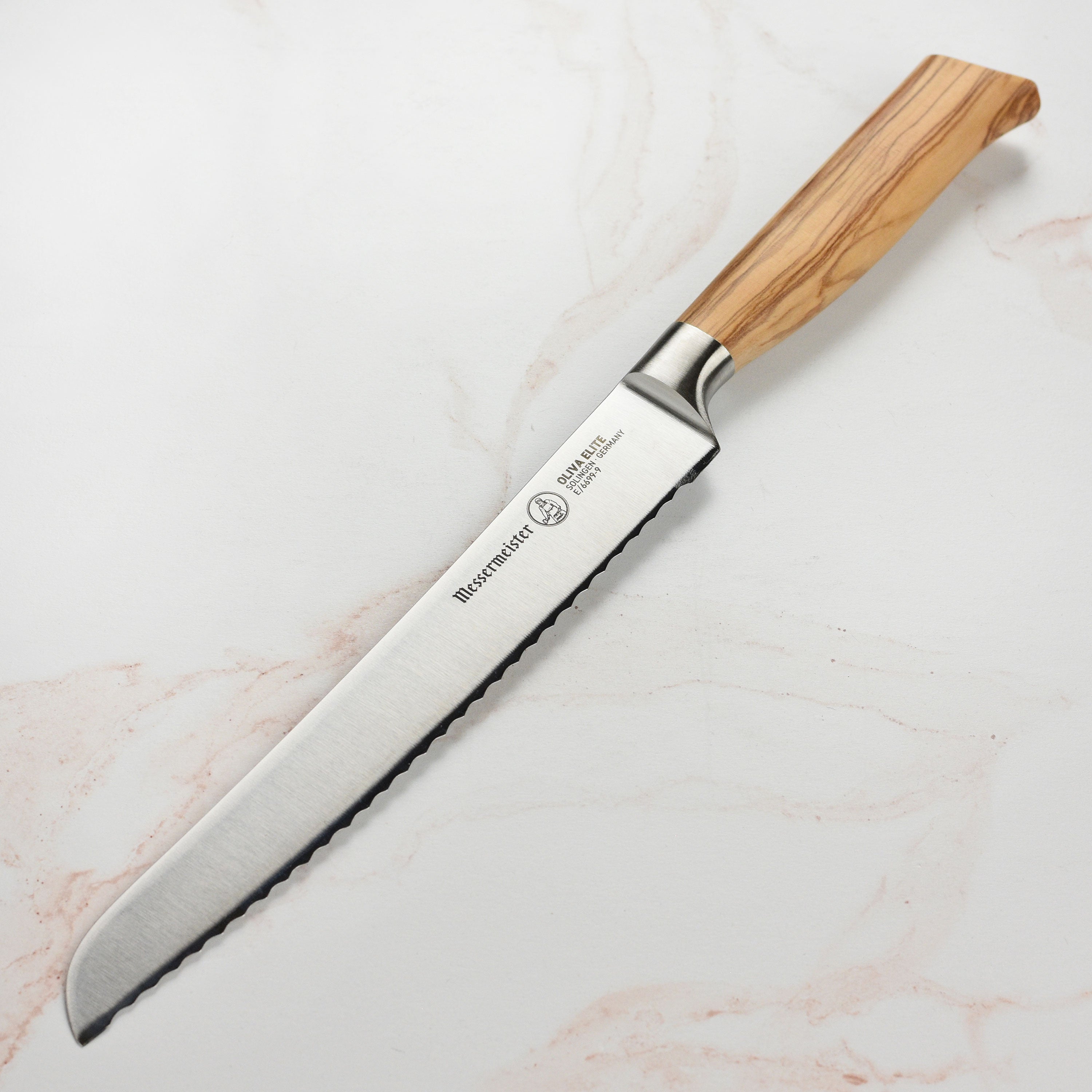 Messermeister Oliva Elite bread knife with olive wood handle slicing artisan bread