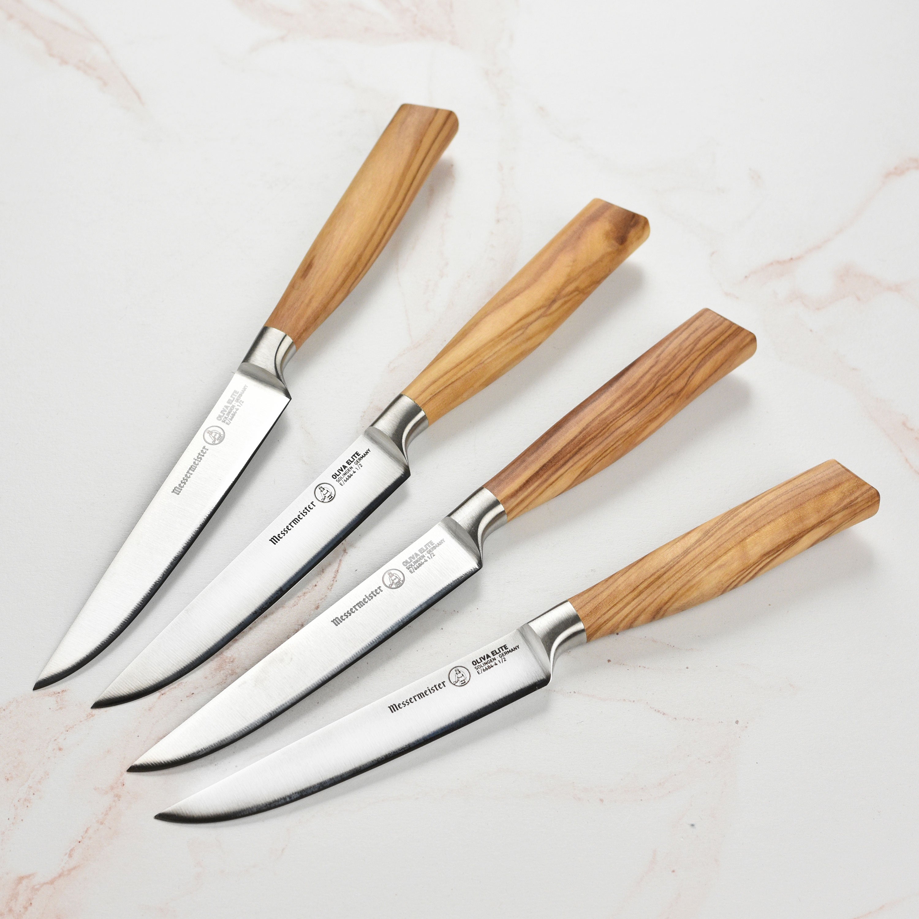 Close-up view of the Elite Italian Olive Wood Steak Knife Set highlighting the fine edge and ergonomic handle.