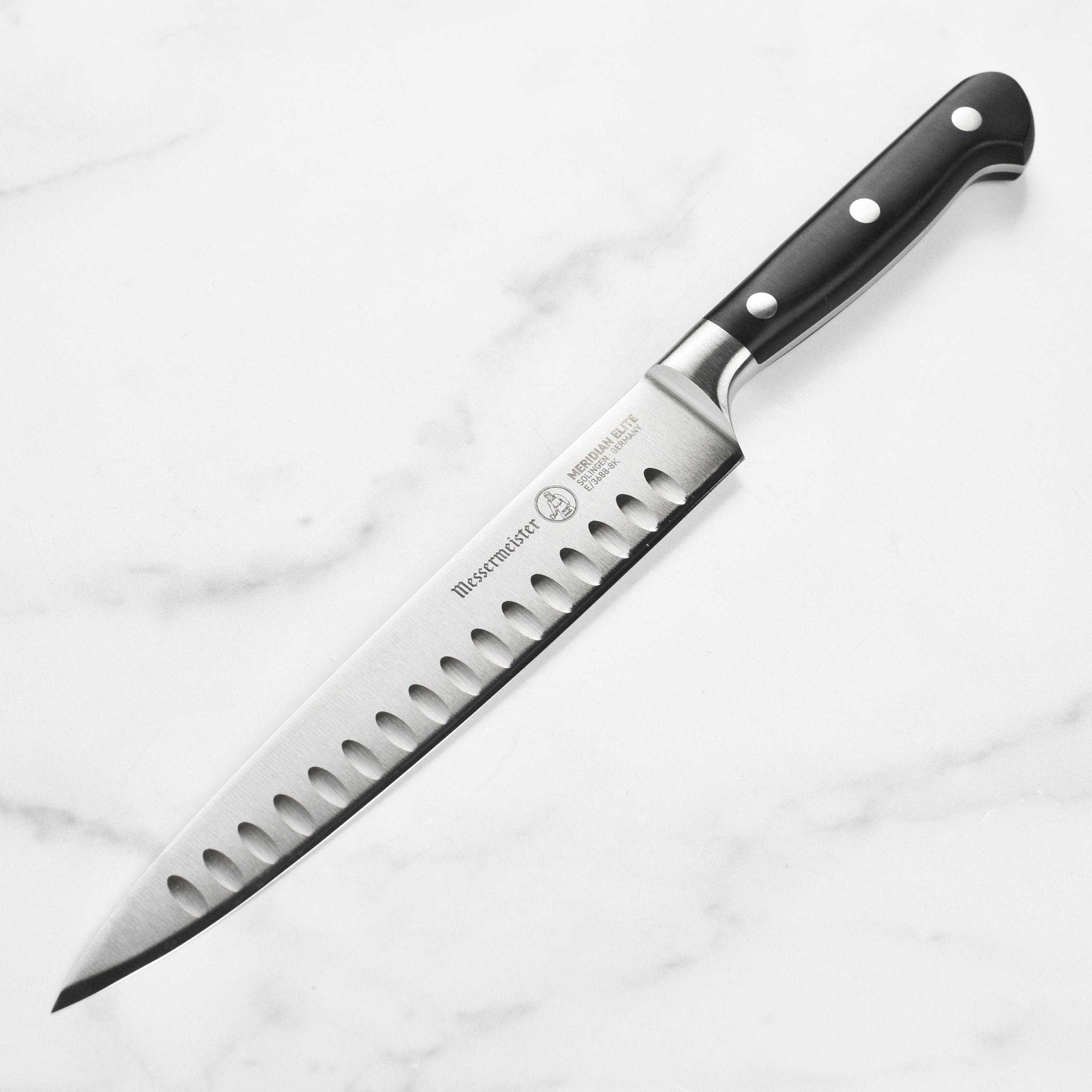 Elite German 8-Inch Hollow Edge Carving Knife from a side view, highlighting its ergonomic handle.