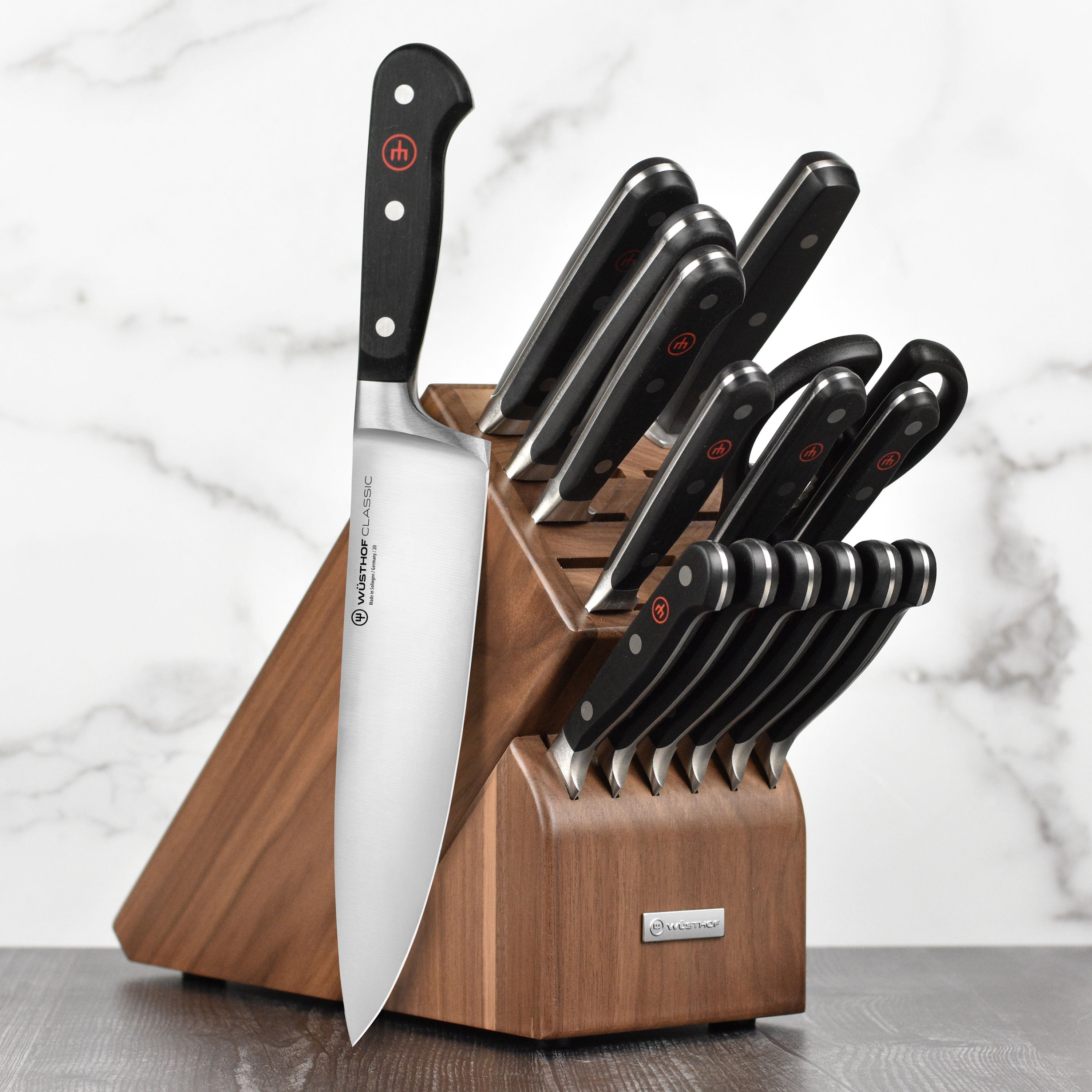 Close-up of Wusthof Classic 16-piece knife set with walnut block in a modern kitchen