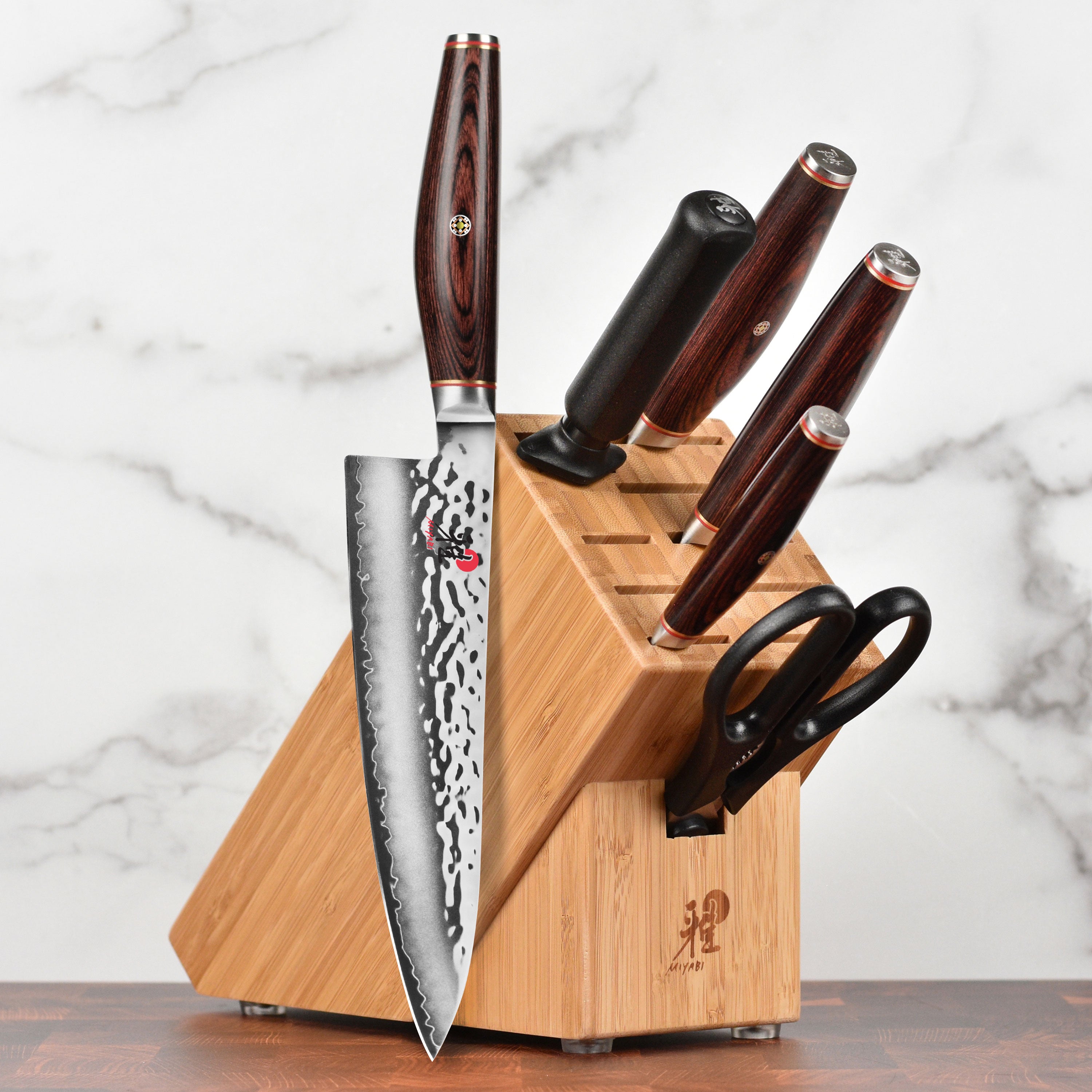 Angled view of the Japanese knife set displayed in the elegant wooden block