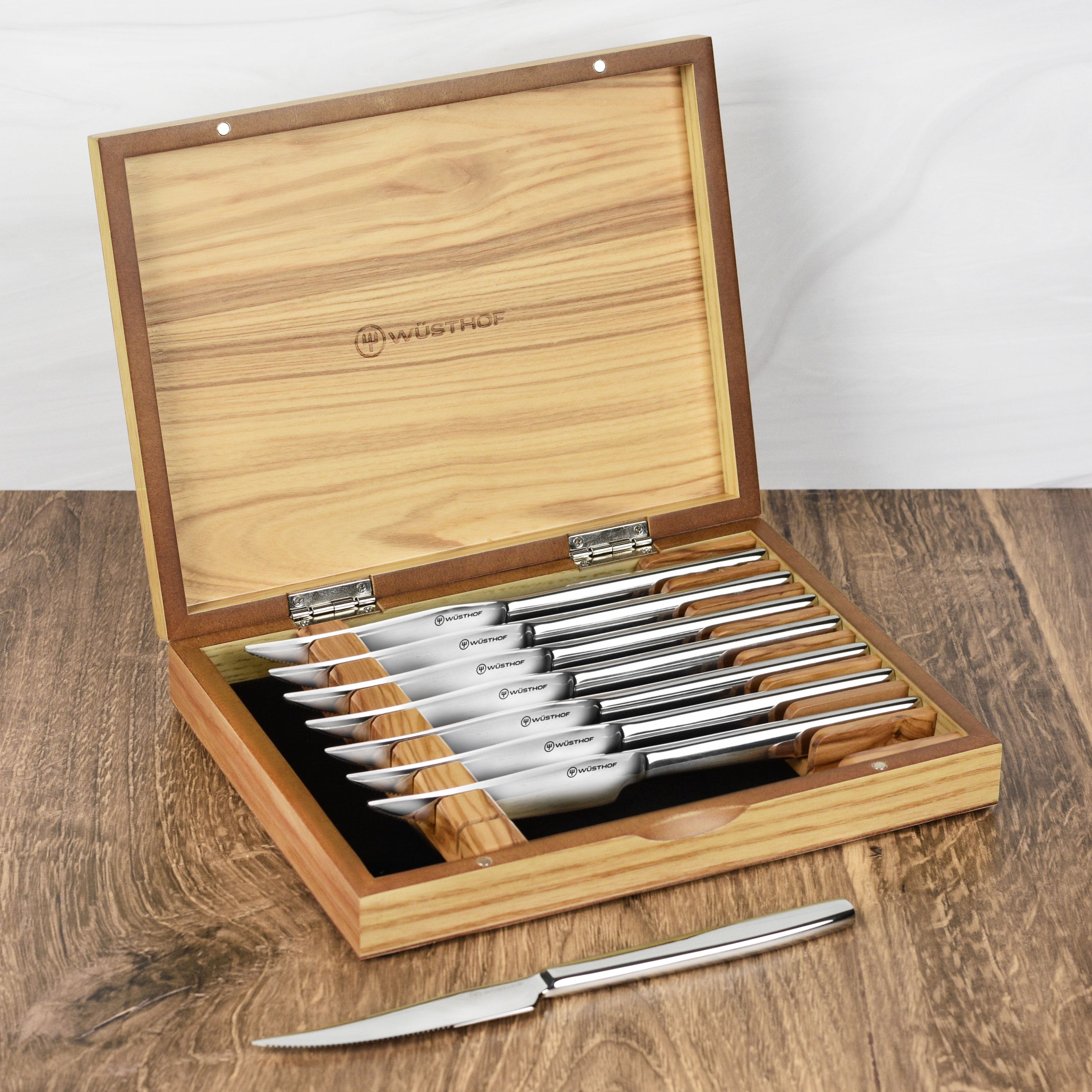 Close-up view of the premium olivewood steak knife set showcasing the serrated blades and polished handles.