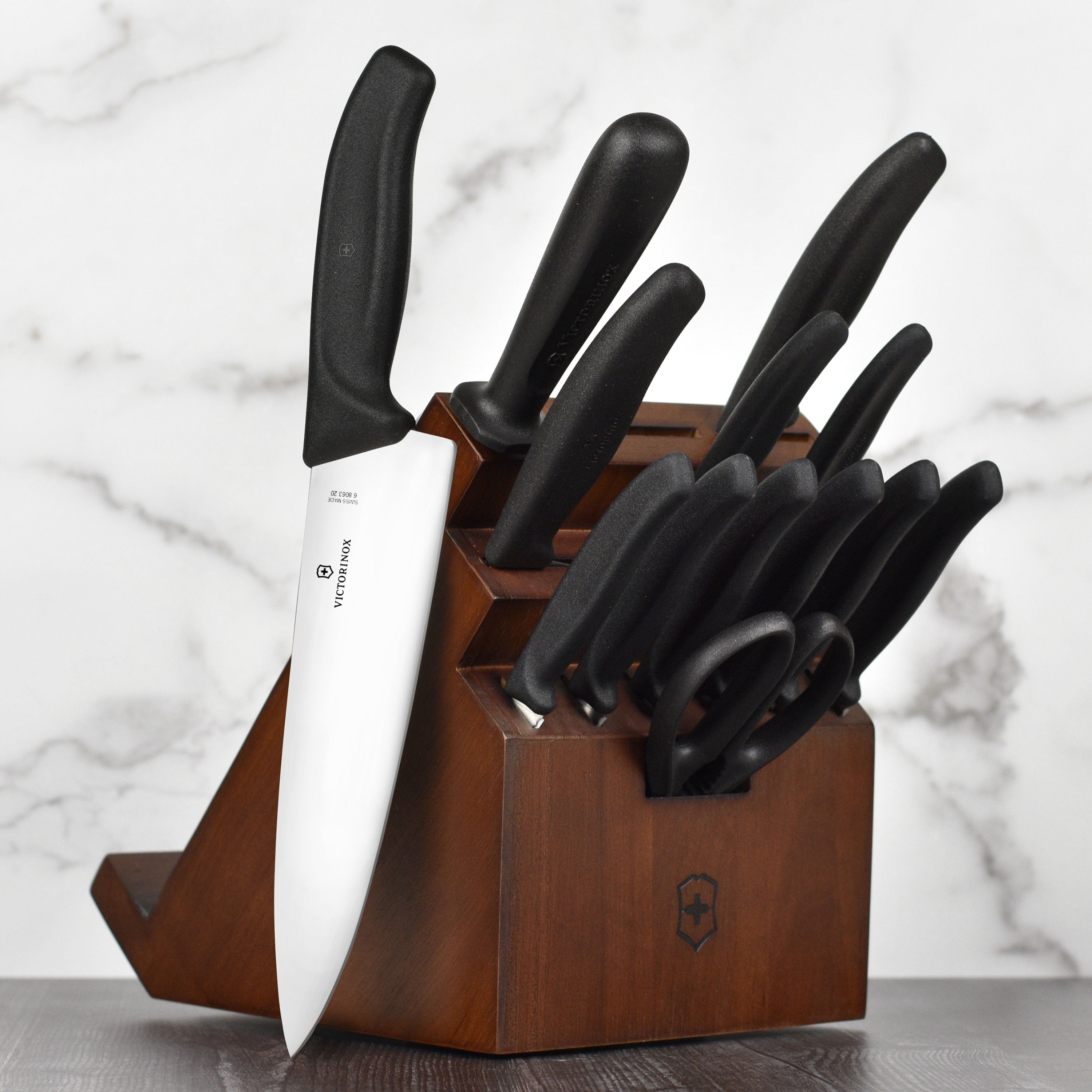 Victorinox knives displayed in walnut block with swivel base on countertop