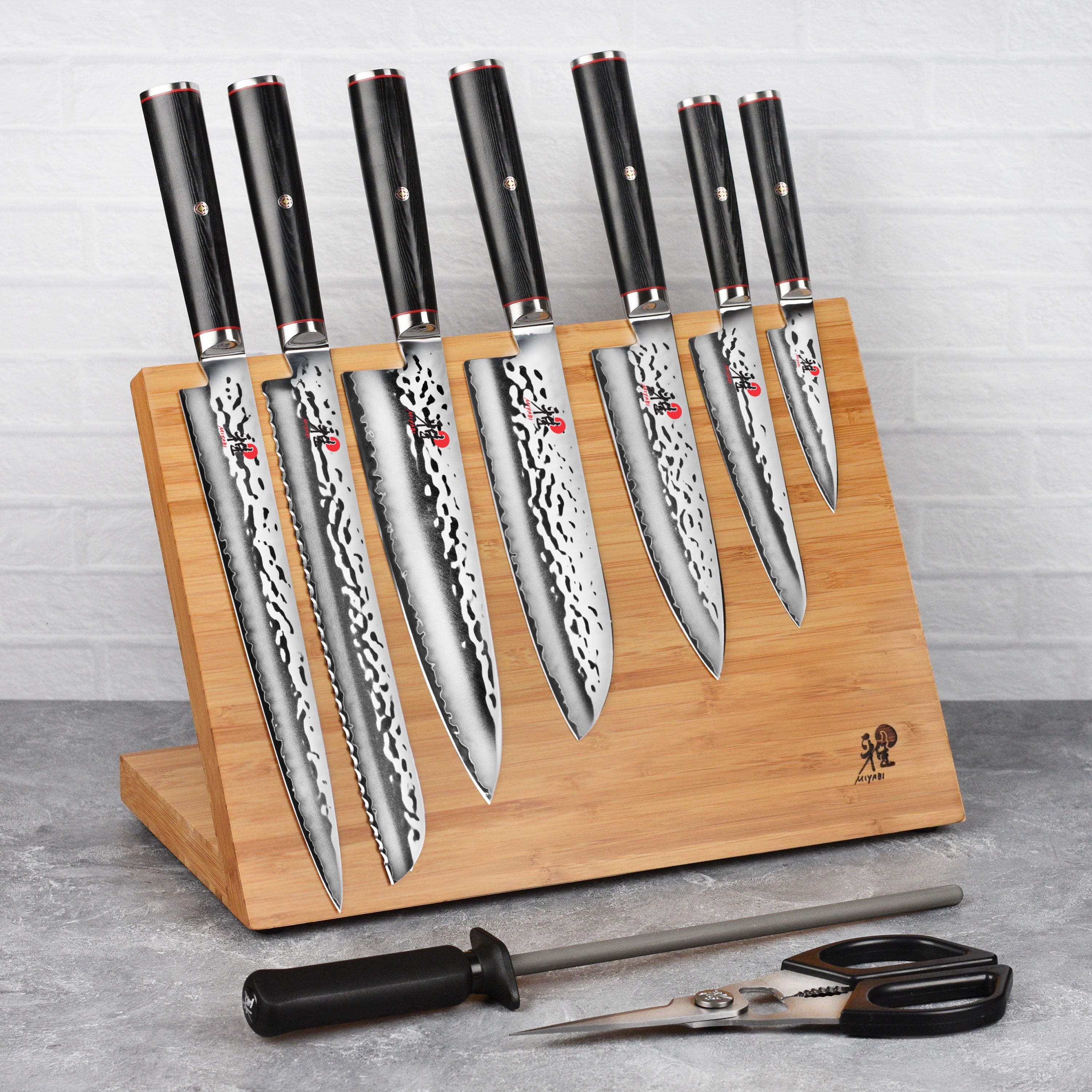 Miyabi Mizu SG2 knife set displayed on a wooden kitchen countertop, highlighting the elegant design and craftsmanship.