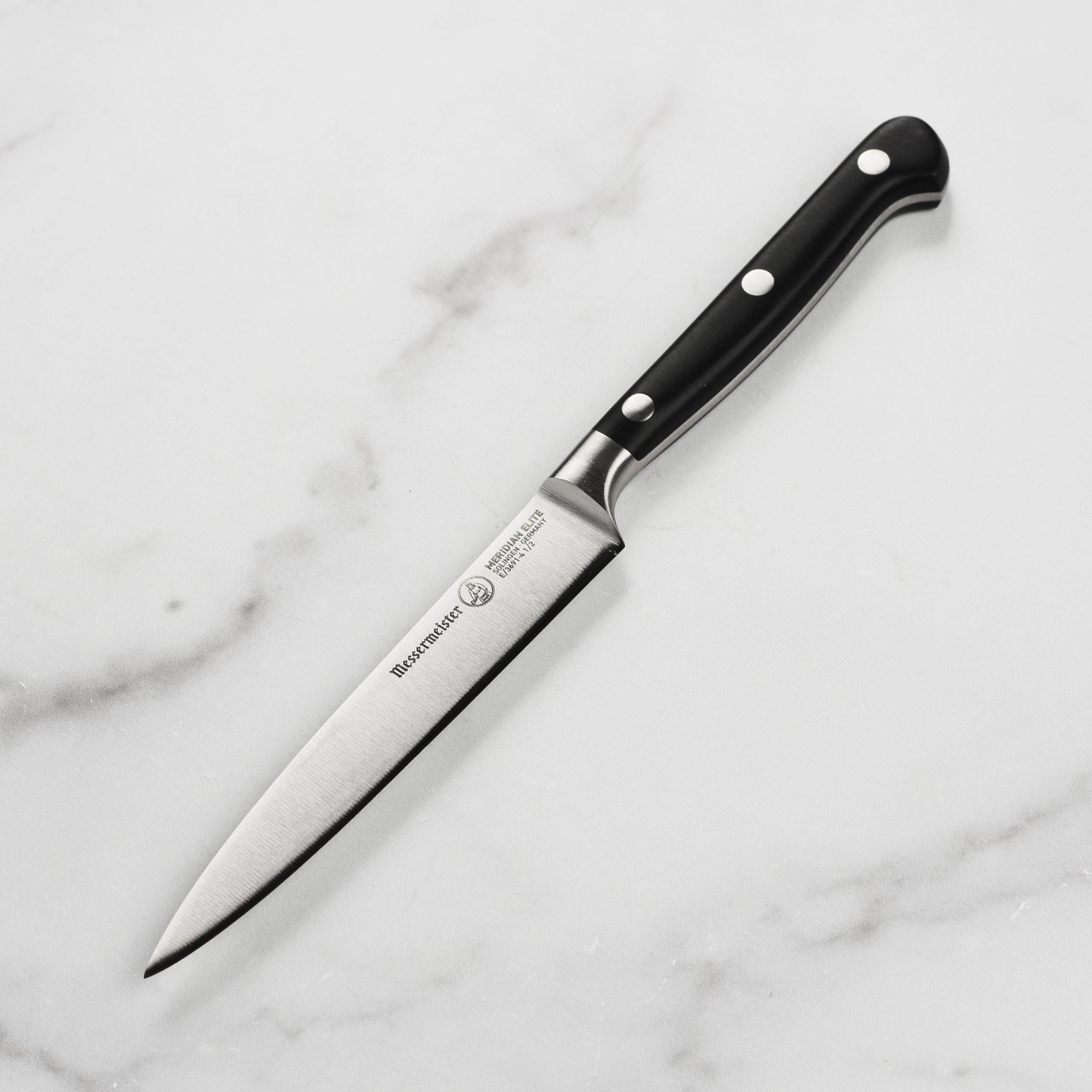 Messermeister Elite Utility Knife angled view showcasing the high carbon stainless steel blade.