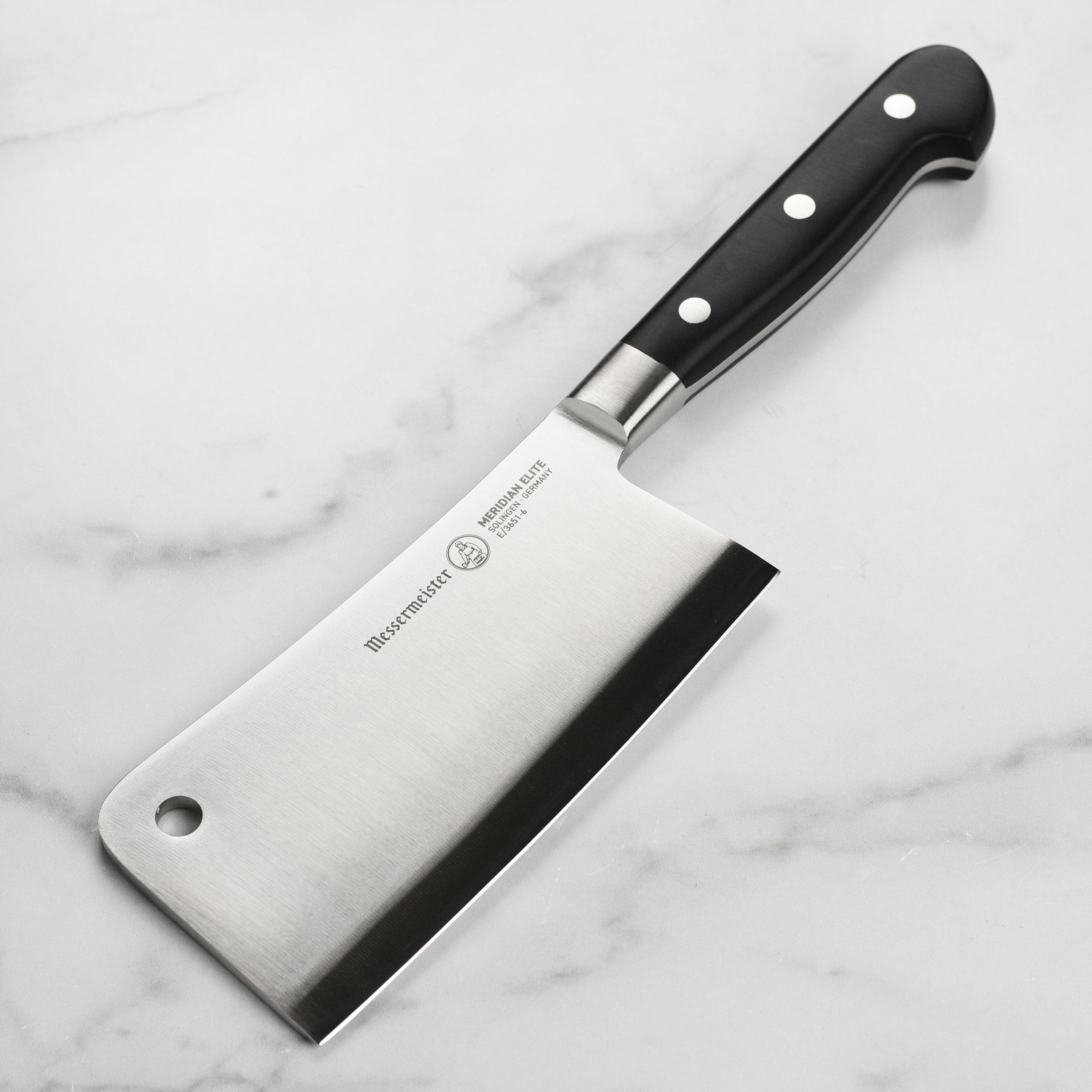 Close-up of forged cleaver blade showcasing polished edge and German steel
