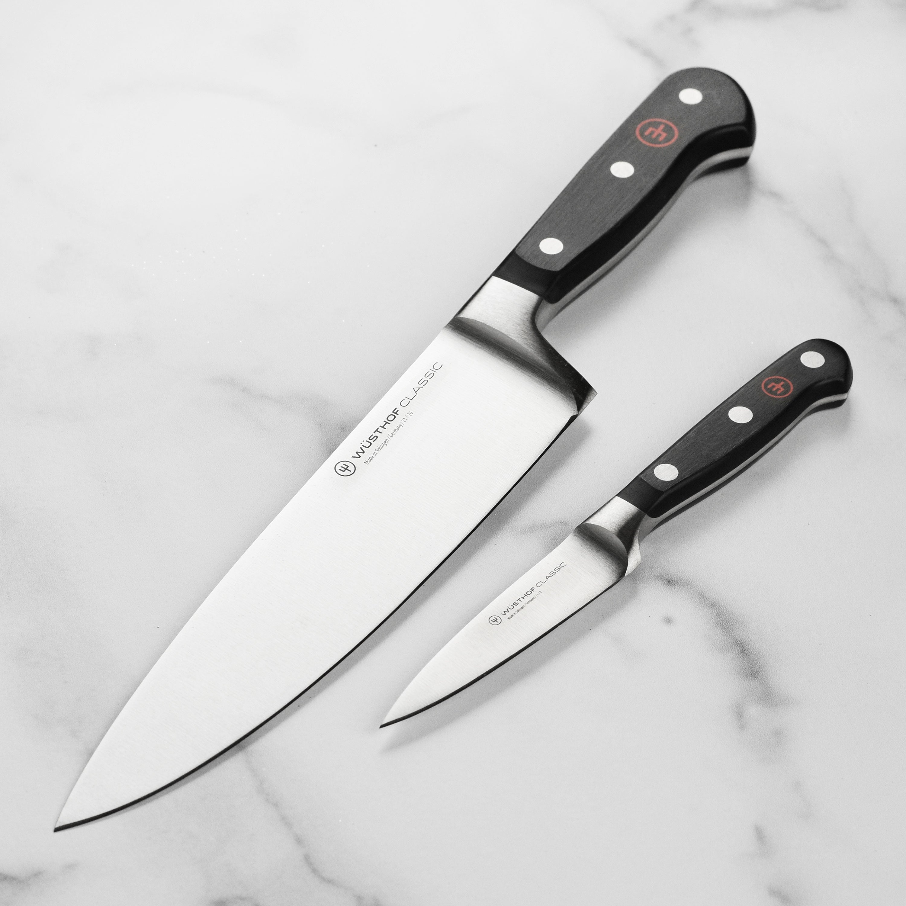 Wusthof Classic Premium Chef Knife Set with a wooden background, showcasing its sharp blades and elegant design.