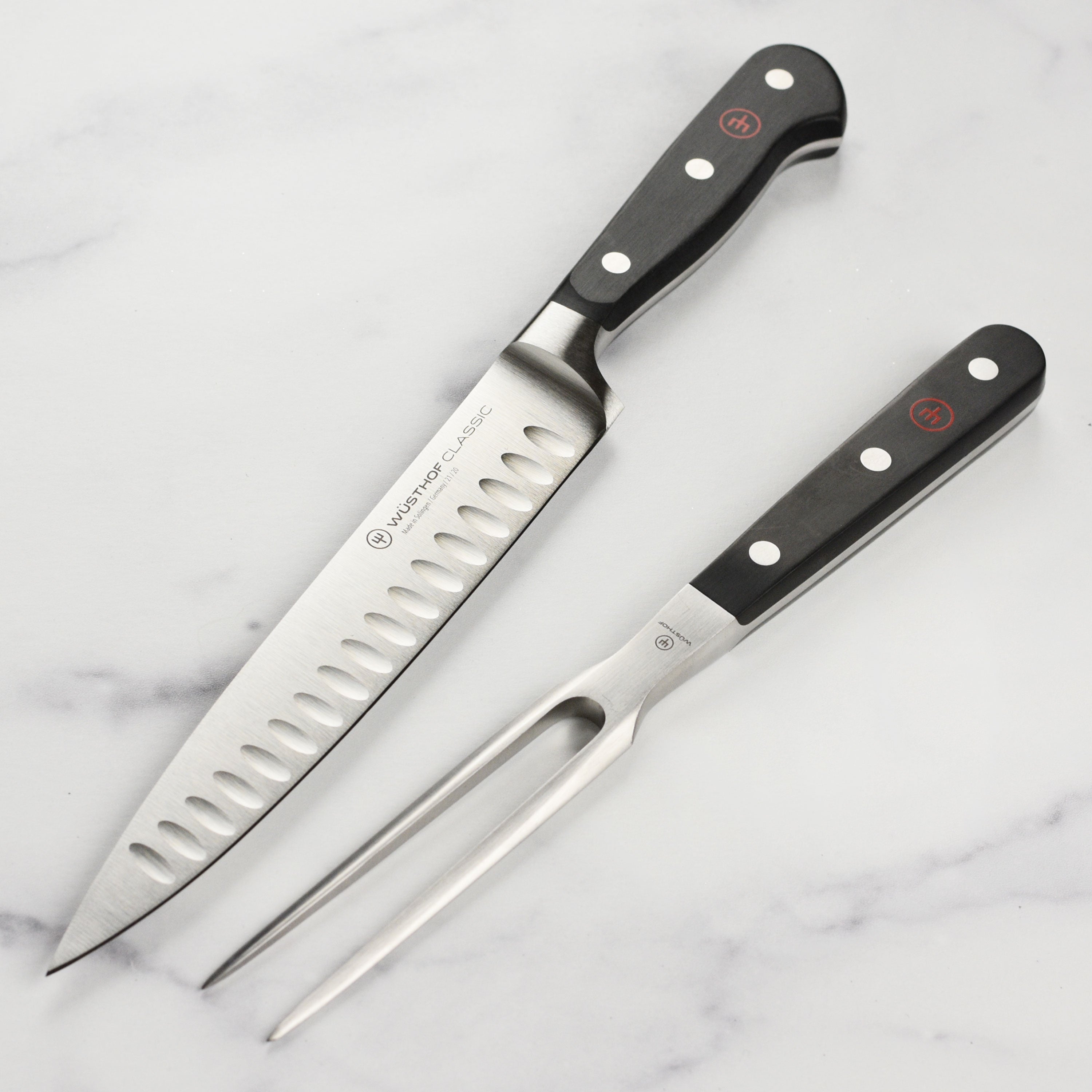 Wusthof Classic carving set with high-carbon stainless steel blades on a wooden cutting board