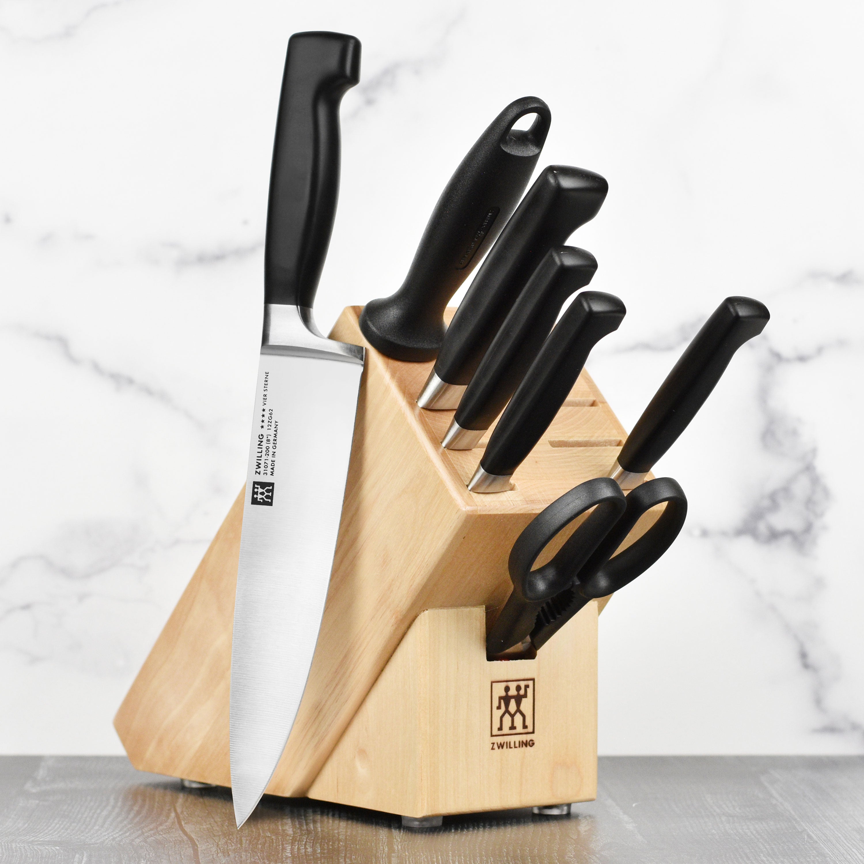 Close-up of Zwilling Four Star chef knife highlighting its sharp blade and ergonomic handle.