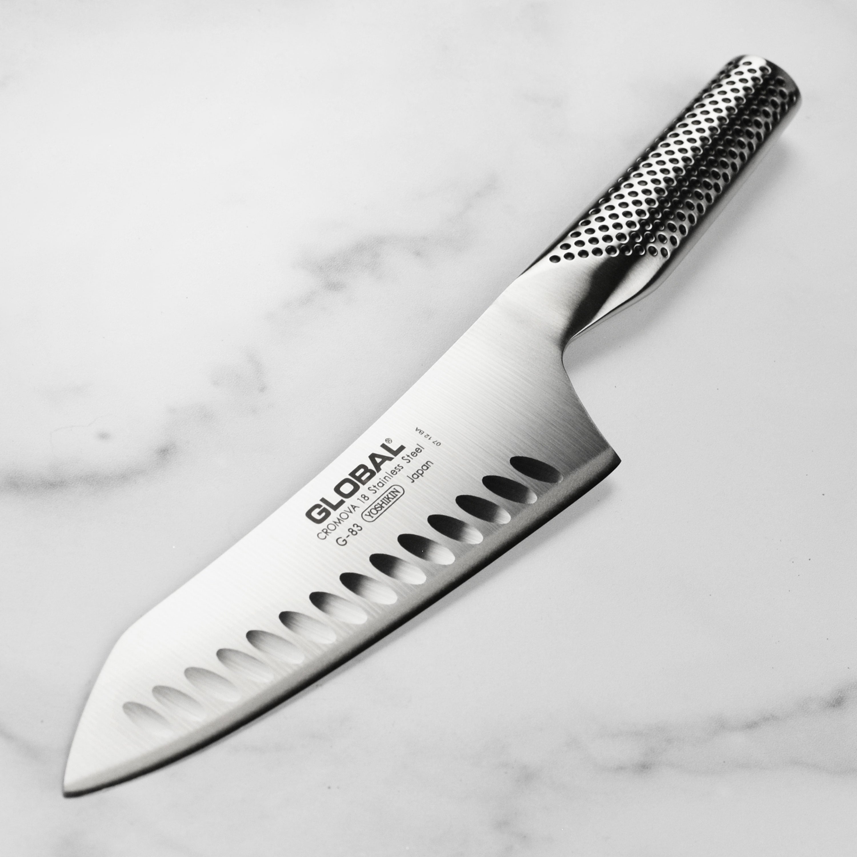 Close-up of KuroEdge 7-inch hollow edge Japanese knife slicing vegetables with ease