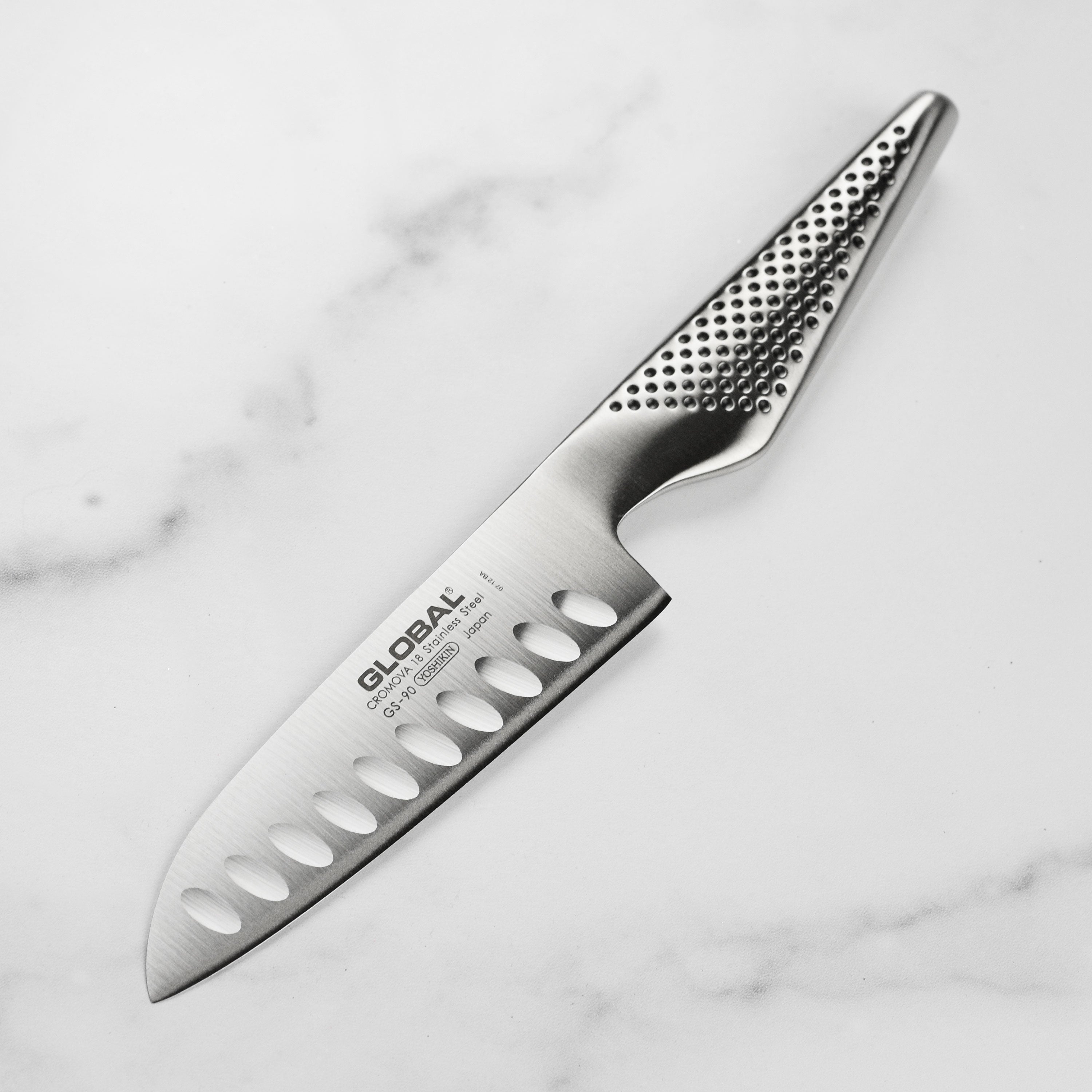Premium hollow edge santoku knife with ergonomic handle, showcasing its high carbon stainless steel blade.