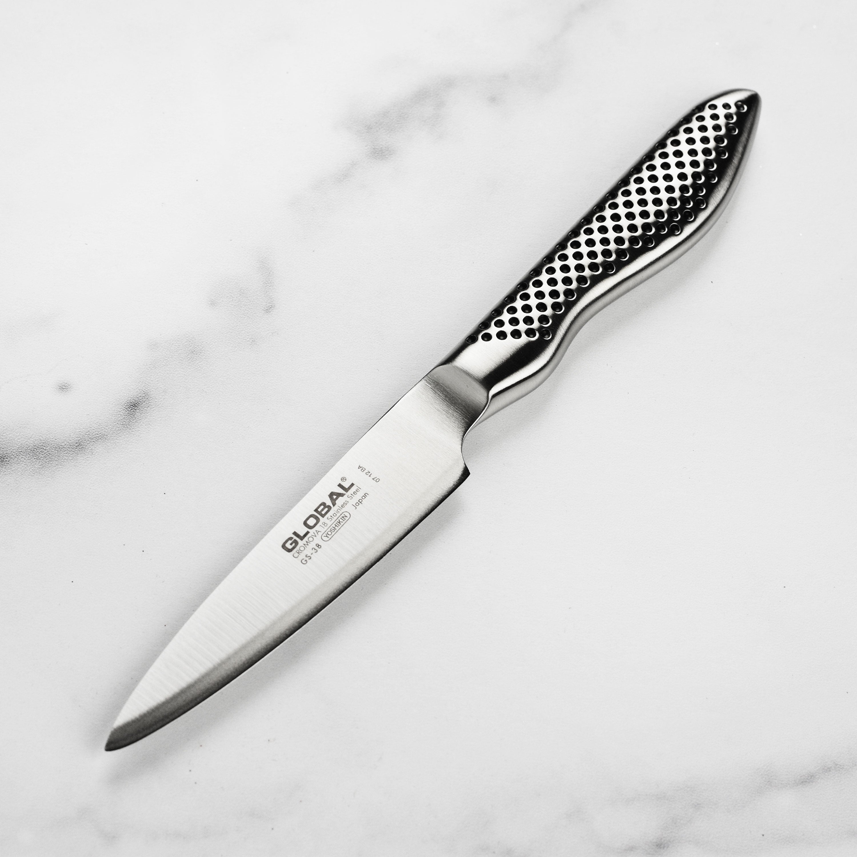 Close-up of the high-quality stainless steel paring knife showcasing the sharp edge and dimpled handle.