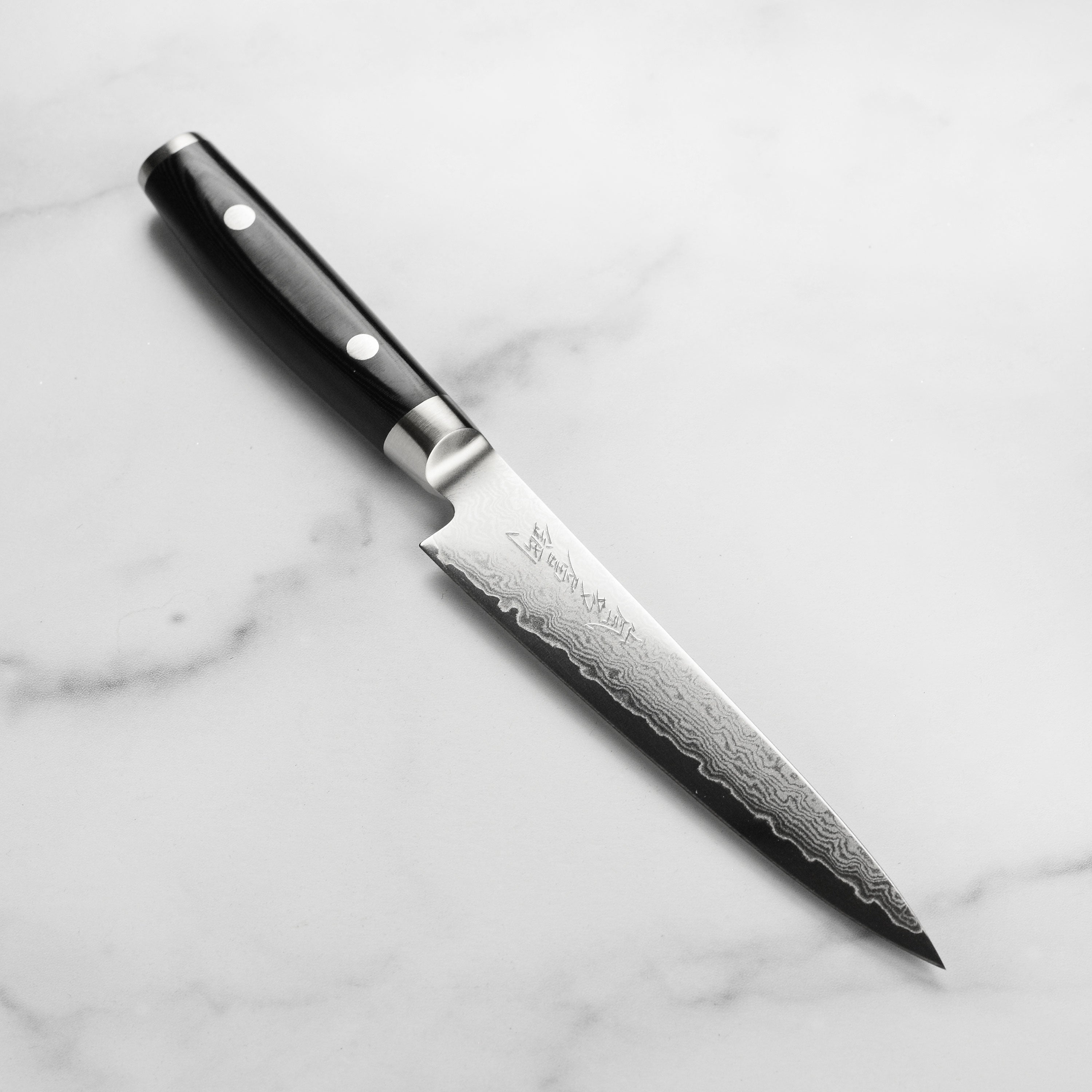 Yaxell Ran Plus 6-inch utility knife with Damascus steel pattern and hand-engraved kanji