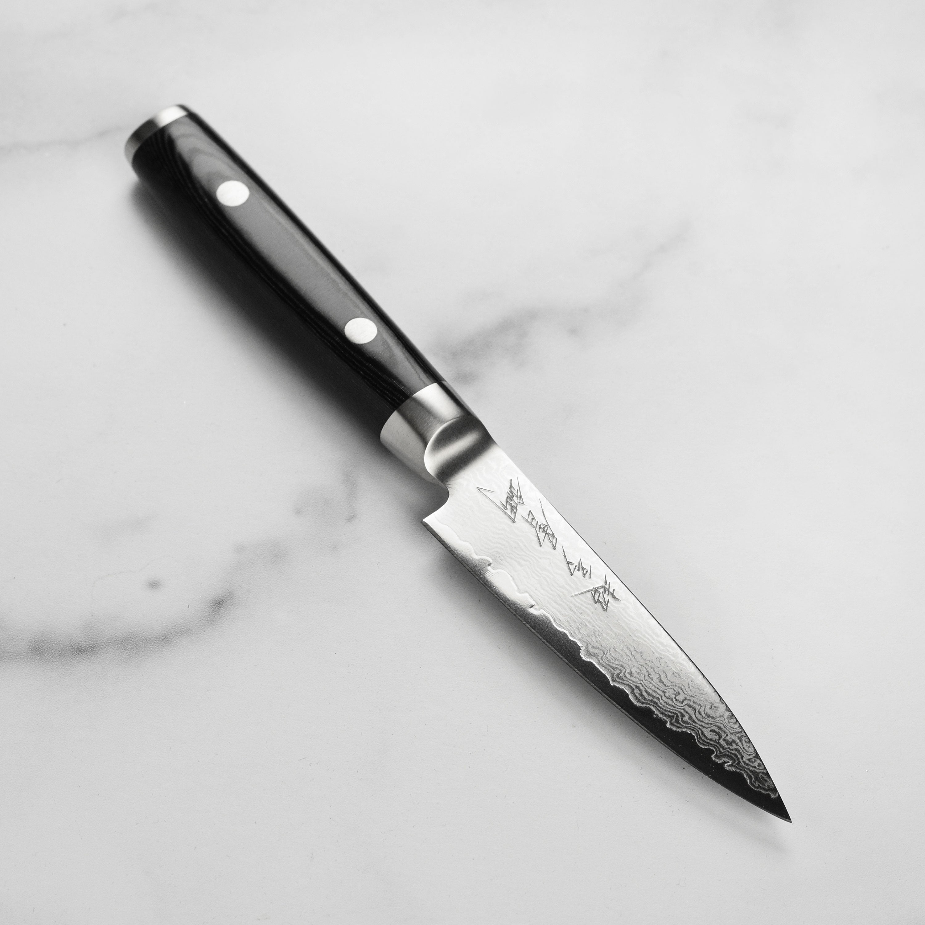 Yaxell Ran Plus 4-inch Damascus paring knife blade with layered steel pattern