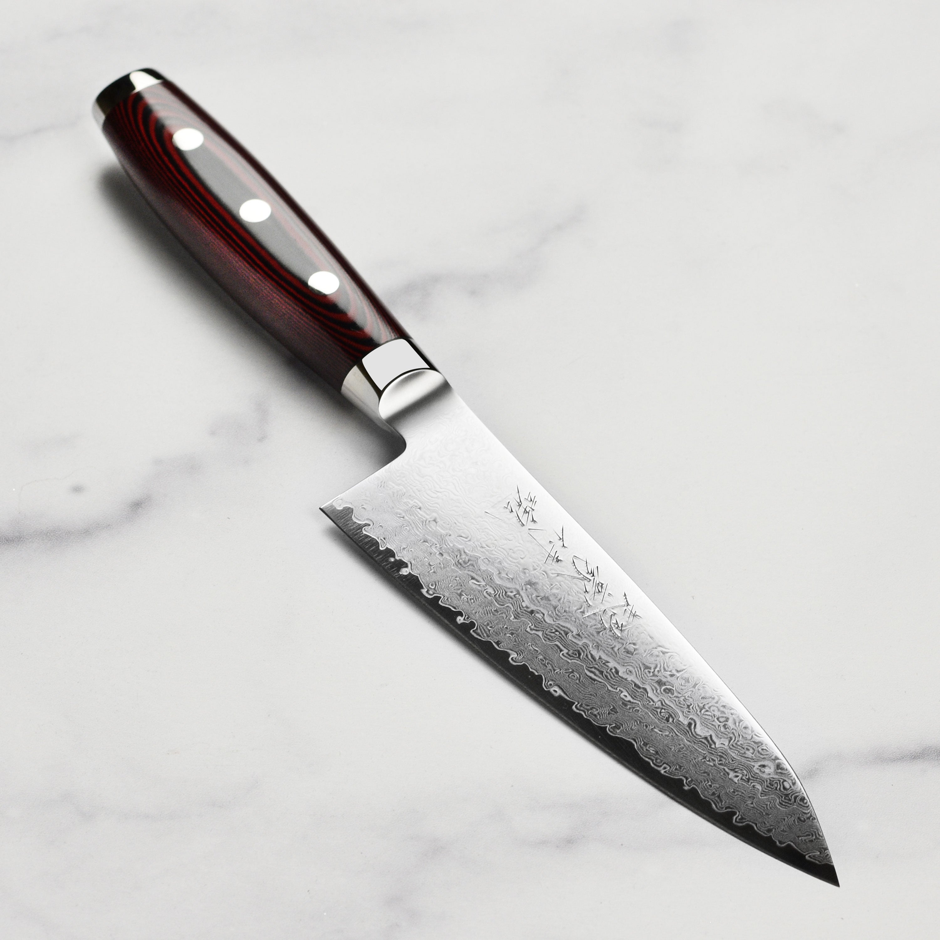 Yaxell Super Gou SG2 6-inch Japanese chef's knife with layered blade detail
