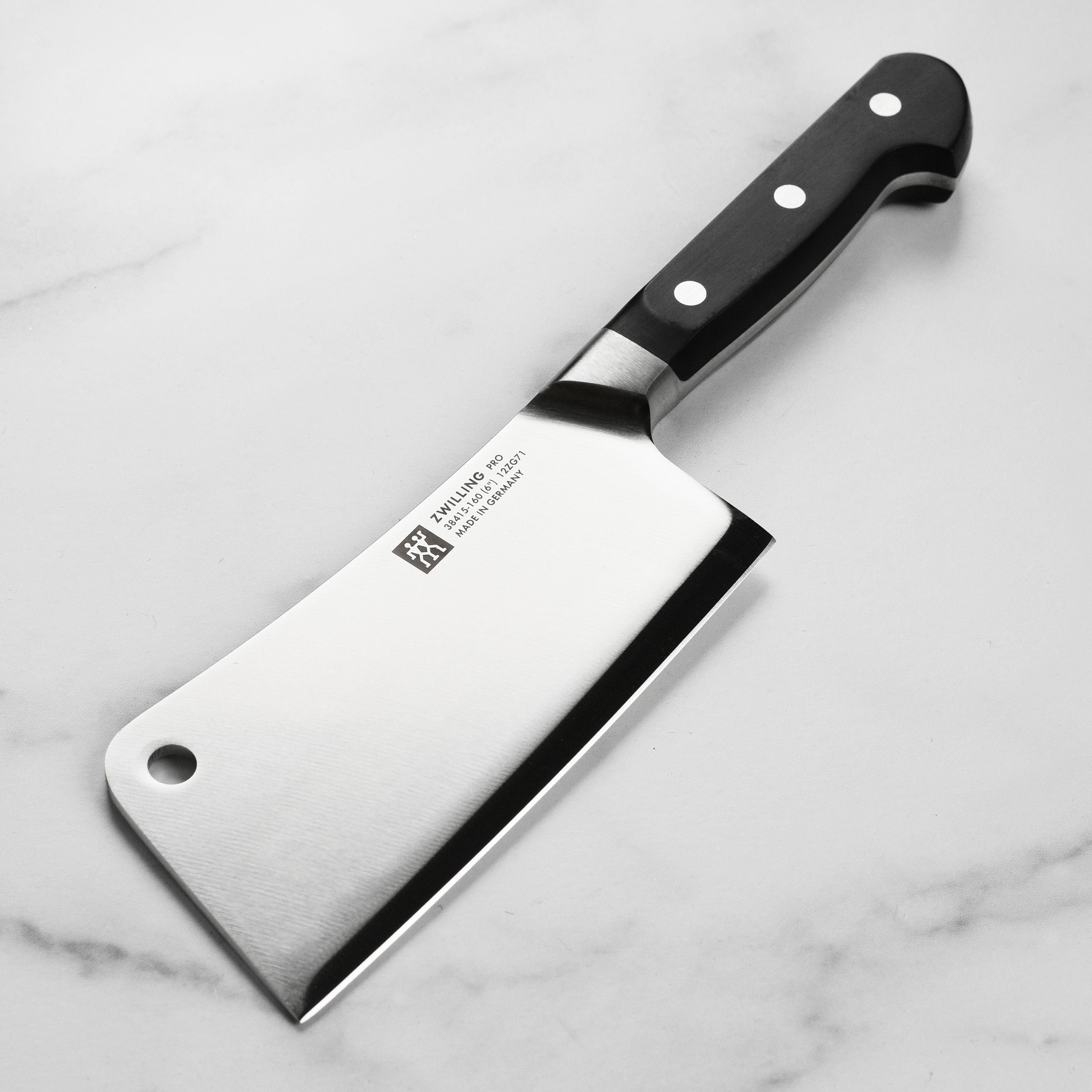 Close-up of Zwilling Pro 6-inch forged meat cleaver blade showing sharp edge and high carbon steel finish